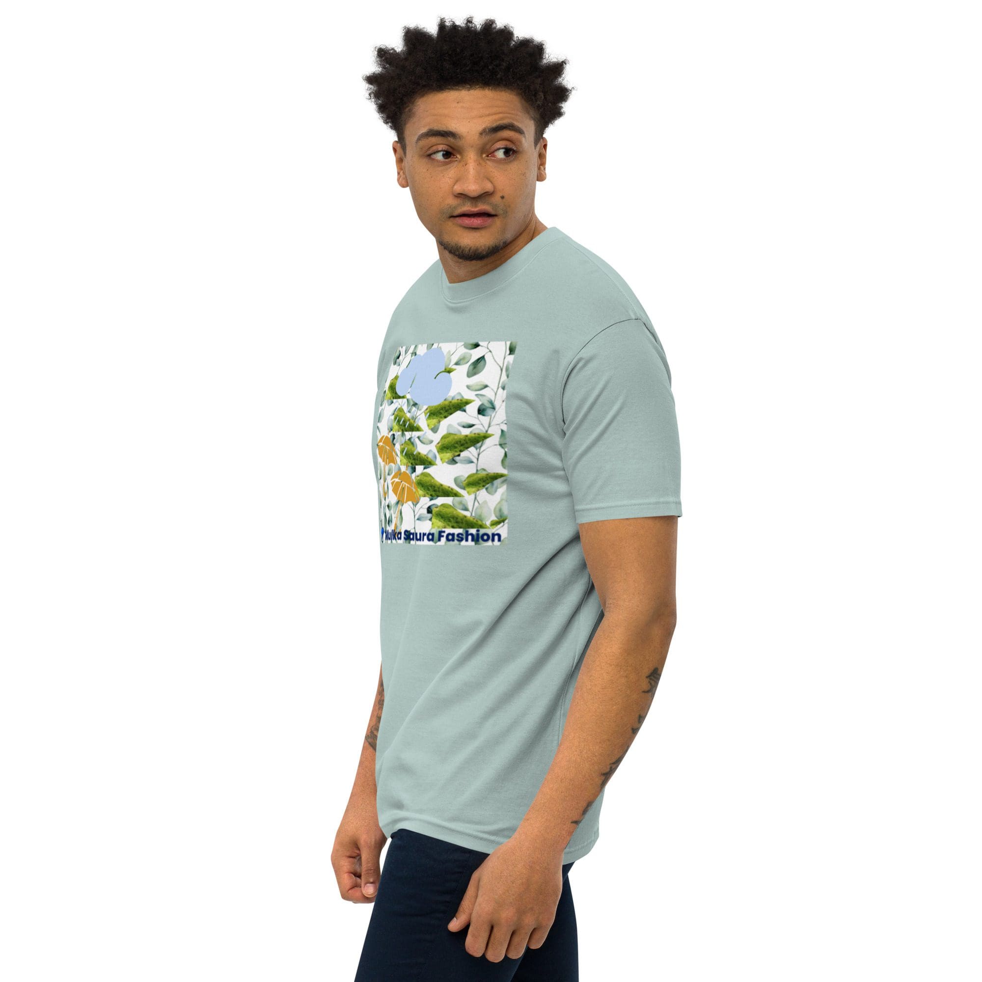 Man in printed blue t-shirt, looking sideways.