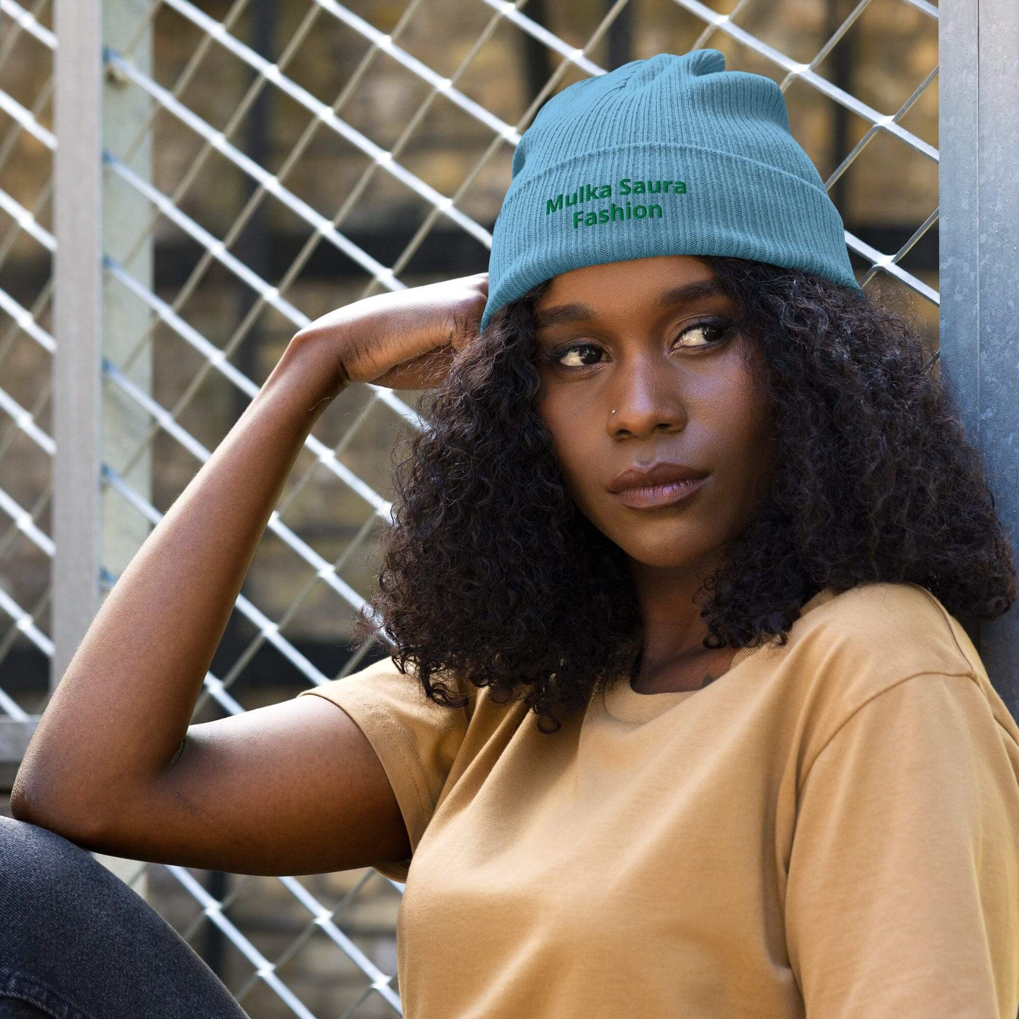 Person wearing blue beanie and tan shirt.