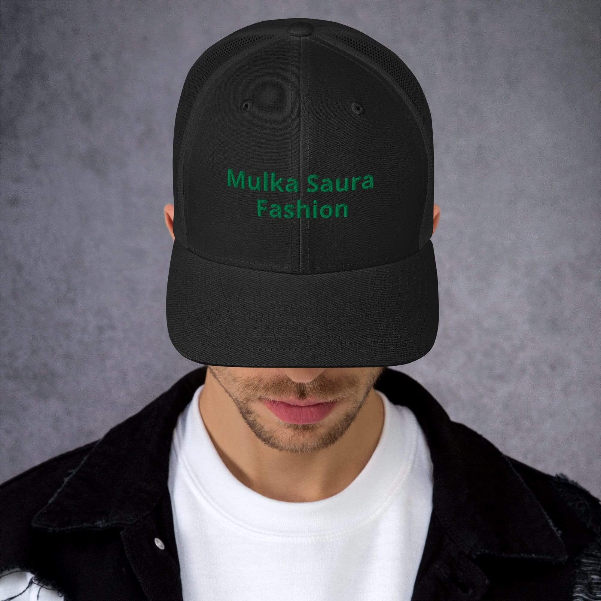 Man wearing black "Mulka Saura Fashion" cap.