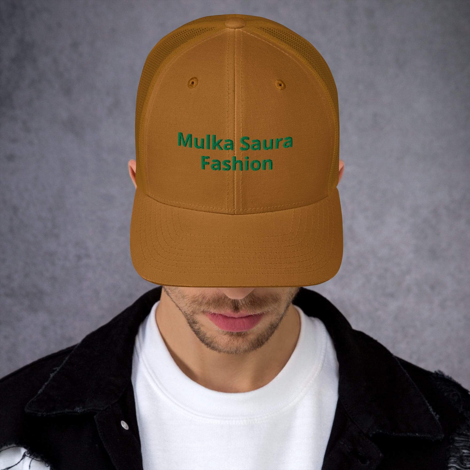 Man wearing brown cap with green text.
