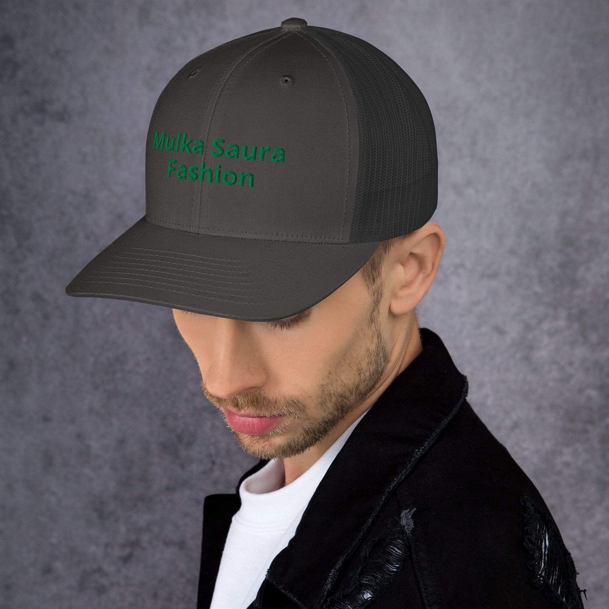 Man wearing black cap with green embroidery