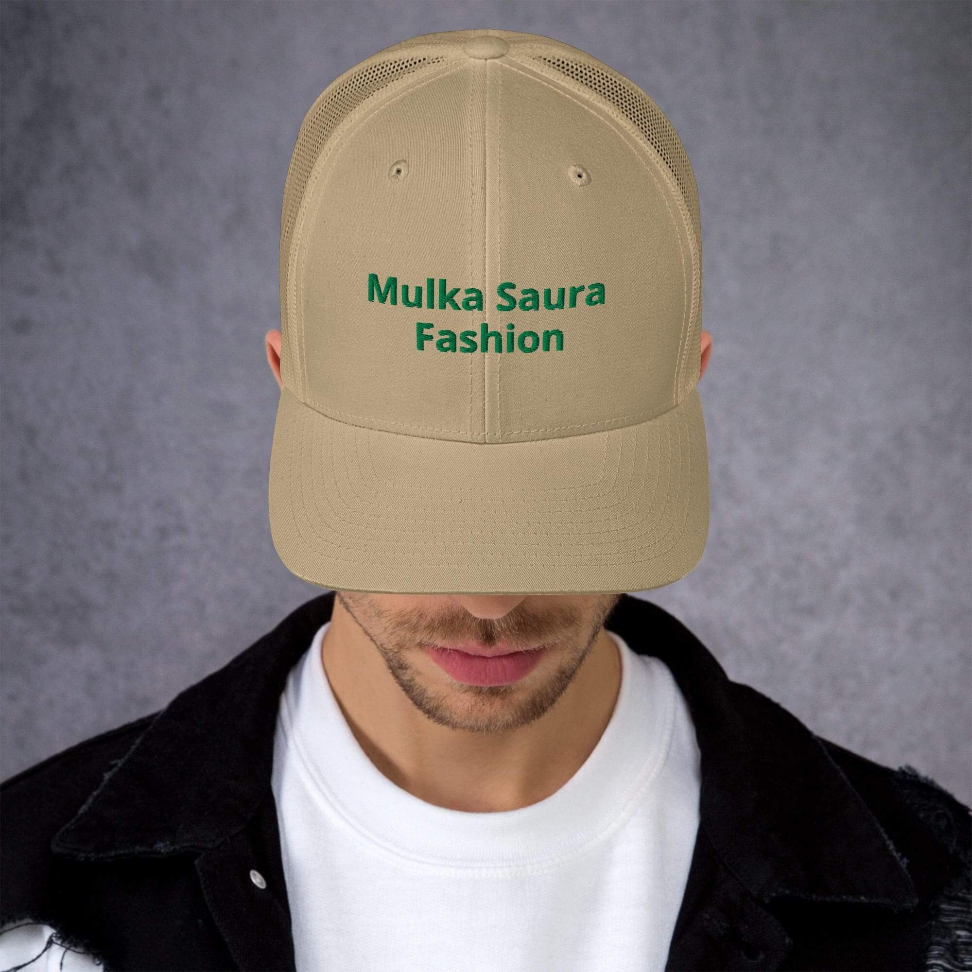 Man wearing beige "Mulka Saura Fashion" cap.