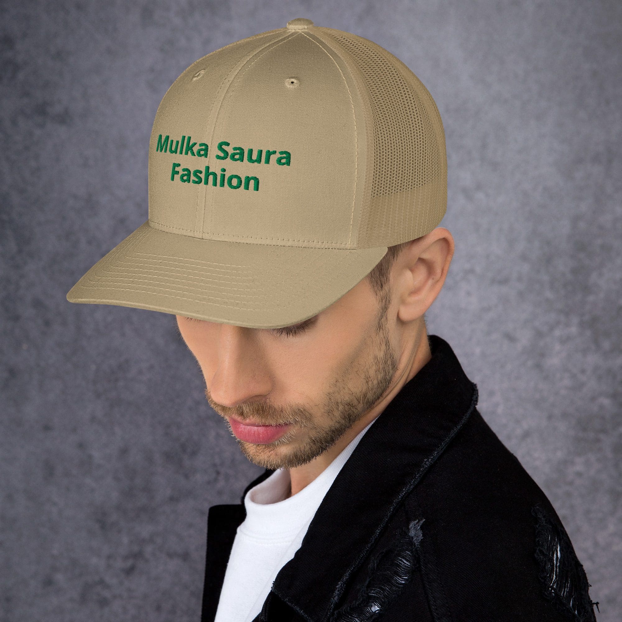 Man wearing beige cap and black jacket.