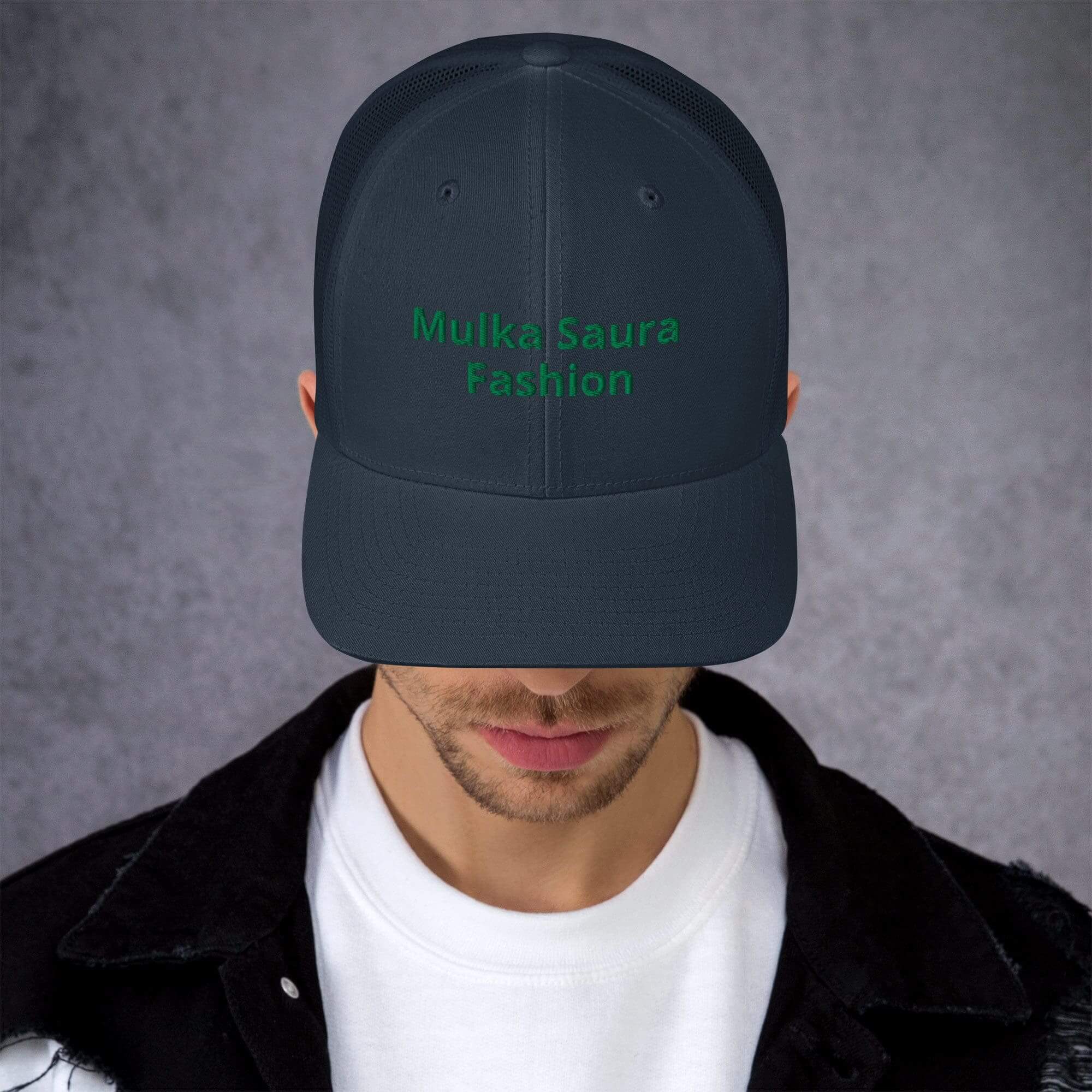 Man wearing a dark cap, head down.