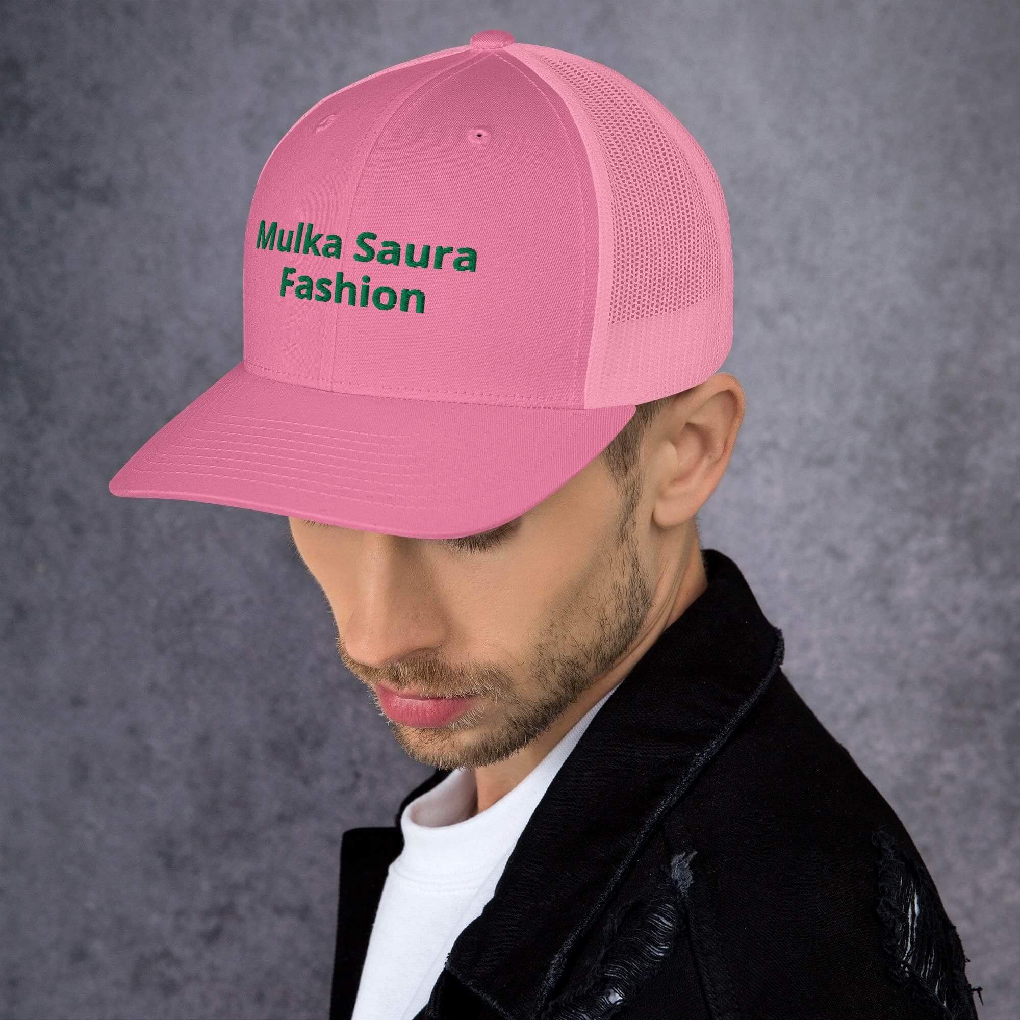 Man wearing pink trucker hat with Mulka Saura