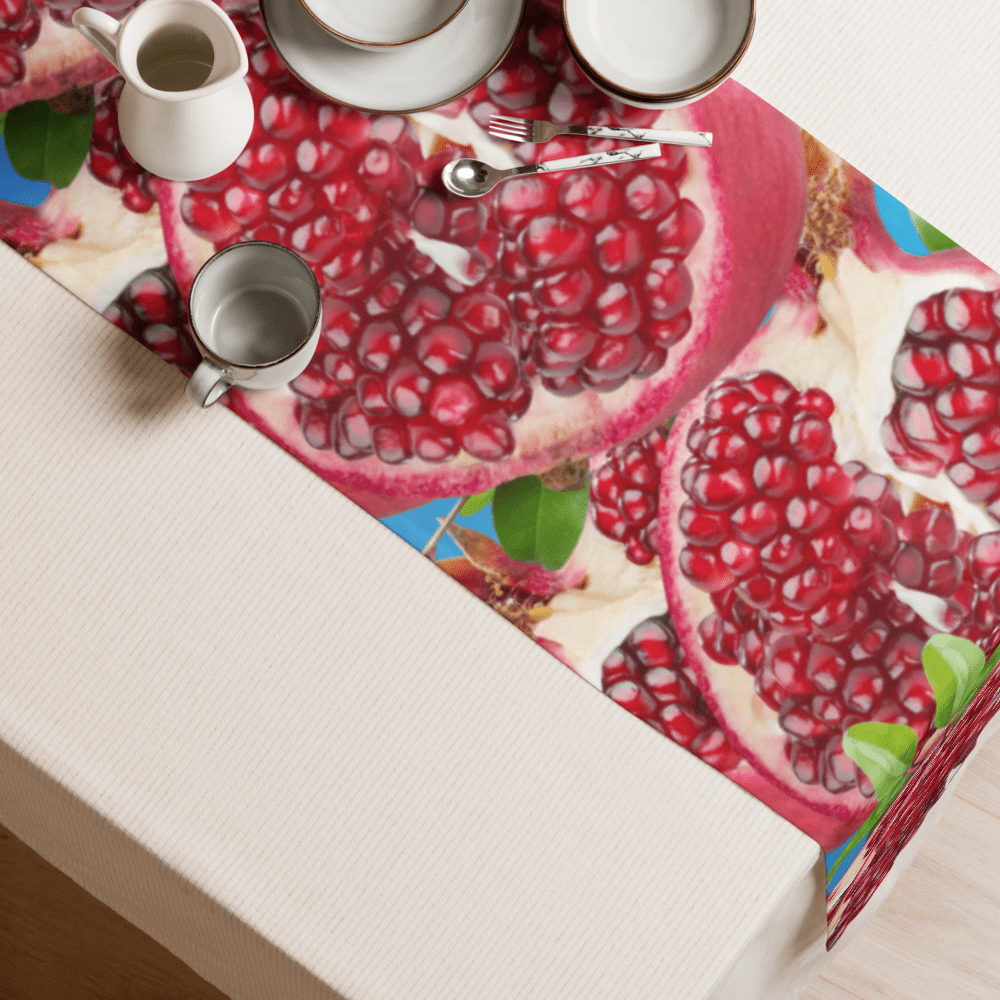 Table setting with pomegranate-themed table runner.