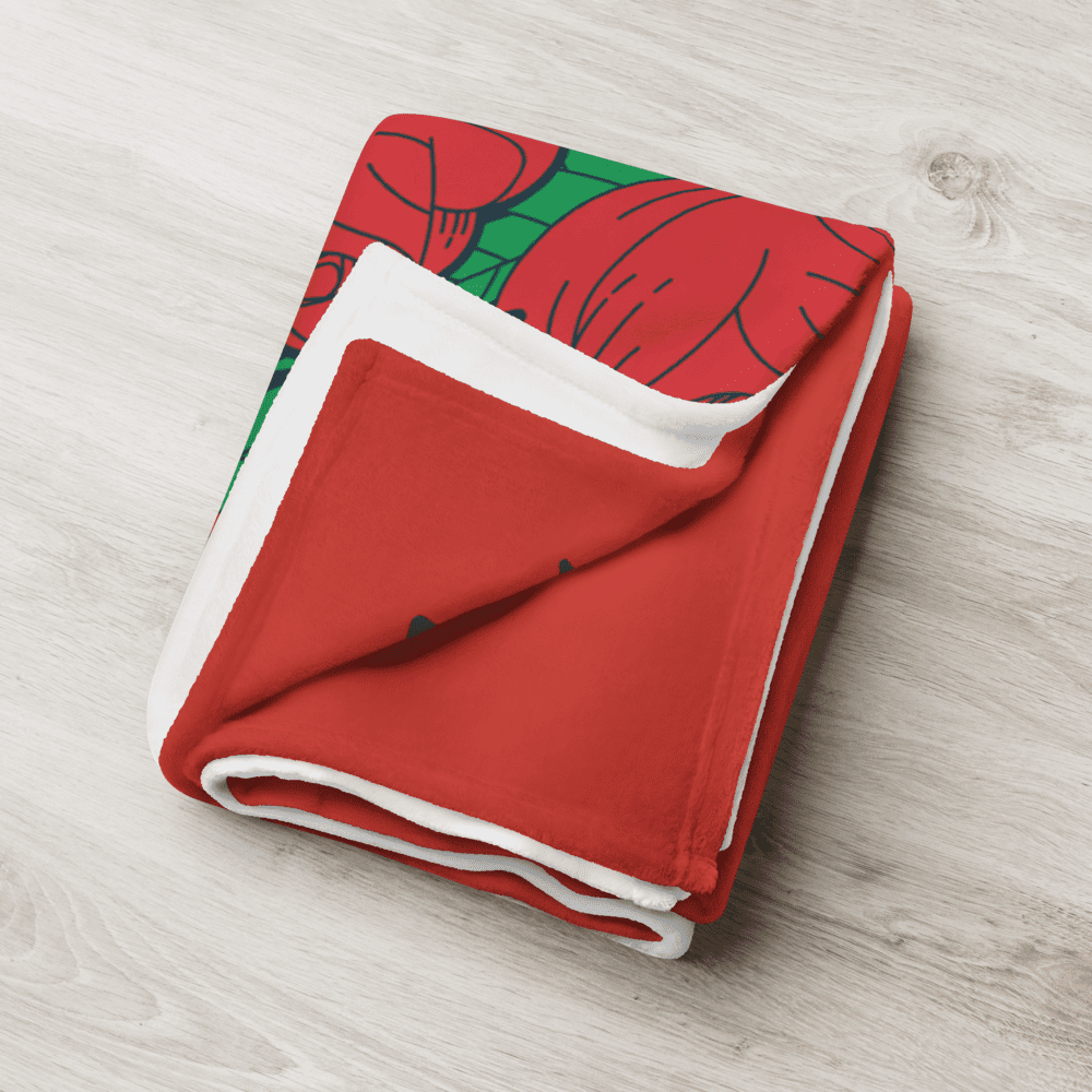 Red and white tulip-patterned blanket folded.