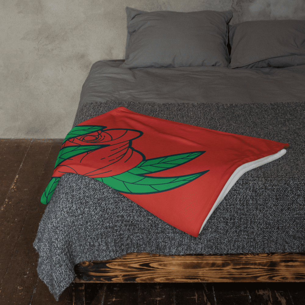 Red rose blanket on gray bedspread.