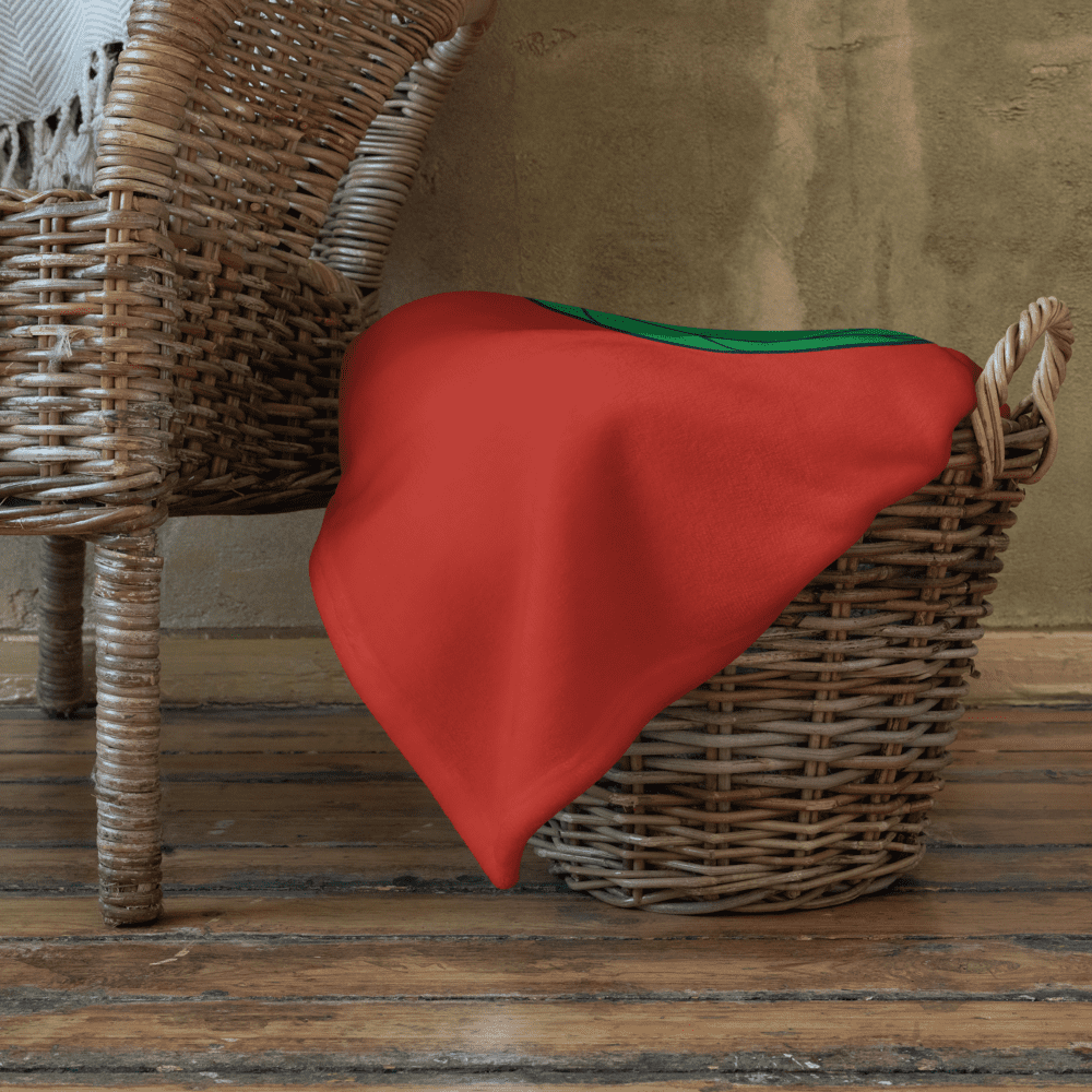 Wicker chairs with a red blanket.