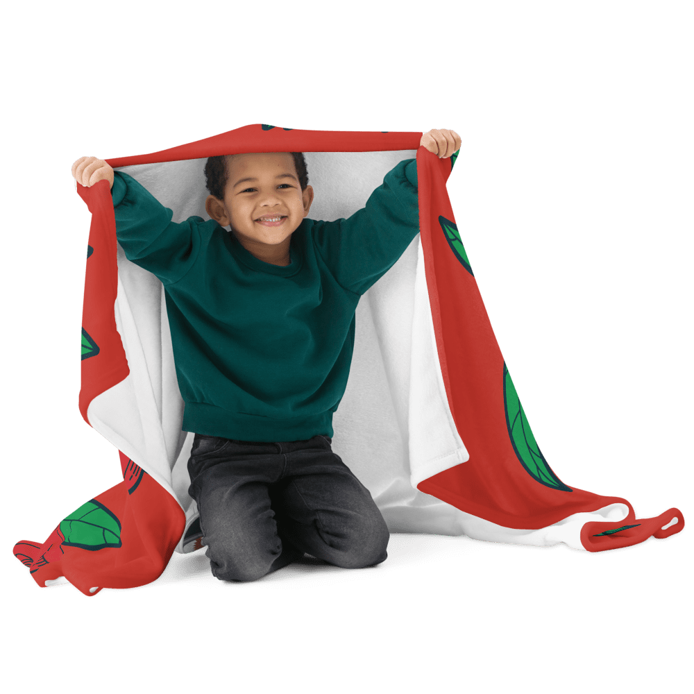 Smiling child wrapped in red leaf blanket