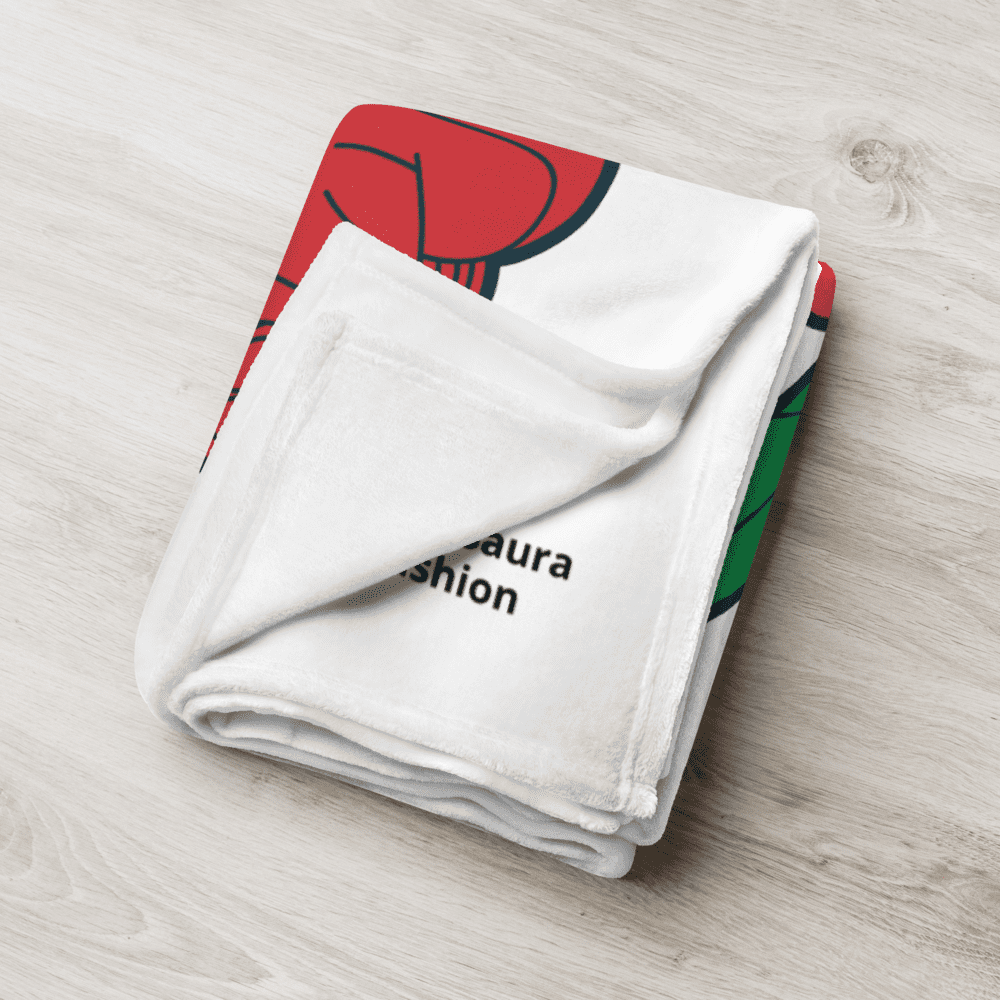 Folded blanket with colorful design on floor.