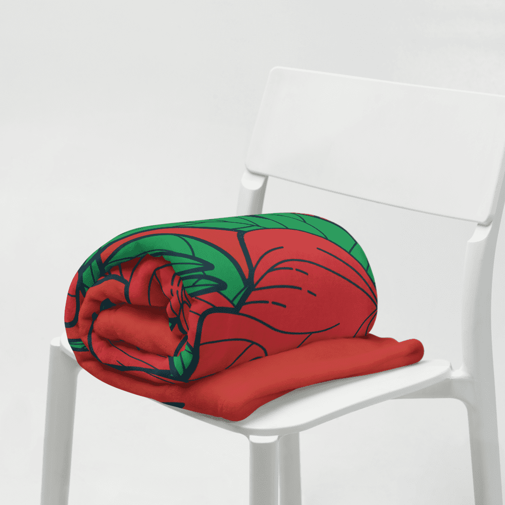 Rolled red floral blanket on white chair