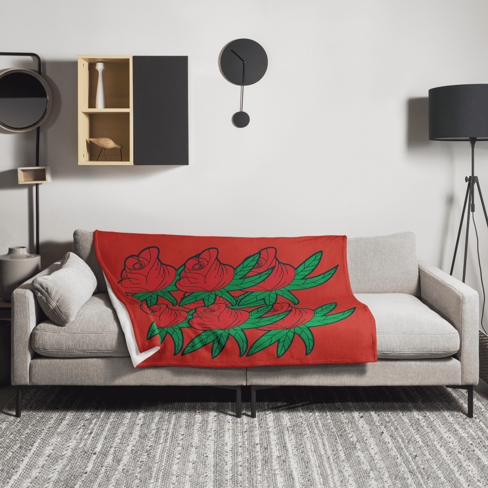 Gray sofa with red floral blanket.