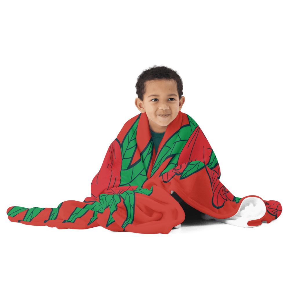 Child wrapped in colorful blanket, smiling.
