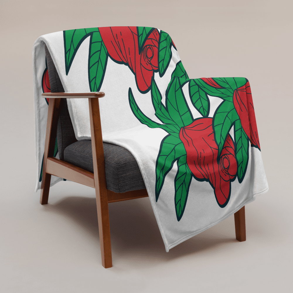 Chair with floral-patterned blanket draped over.