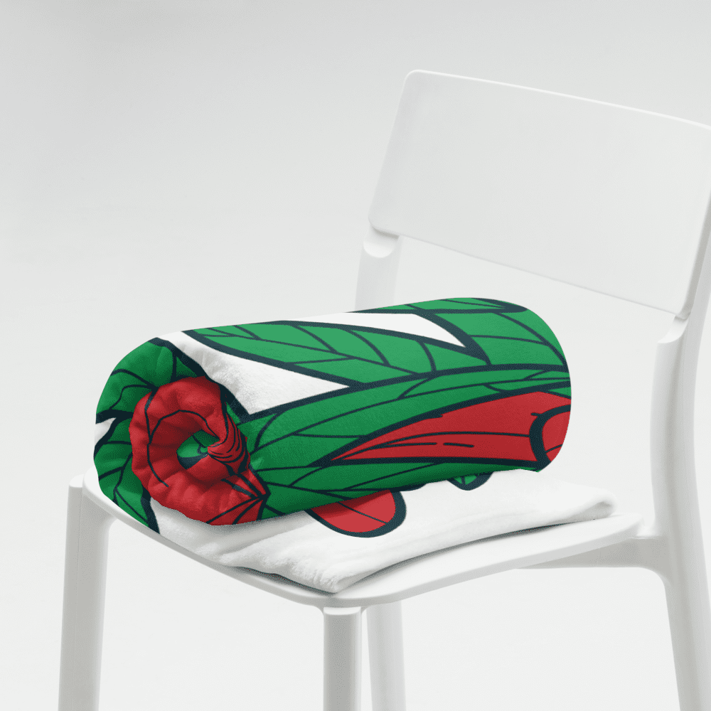 Rolled colorful blanket on white chair.
