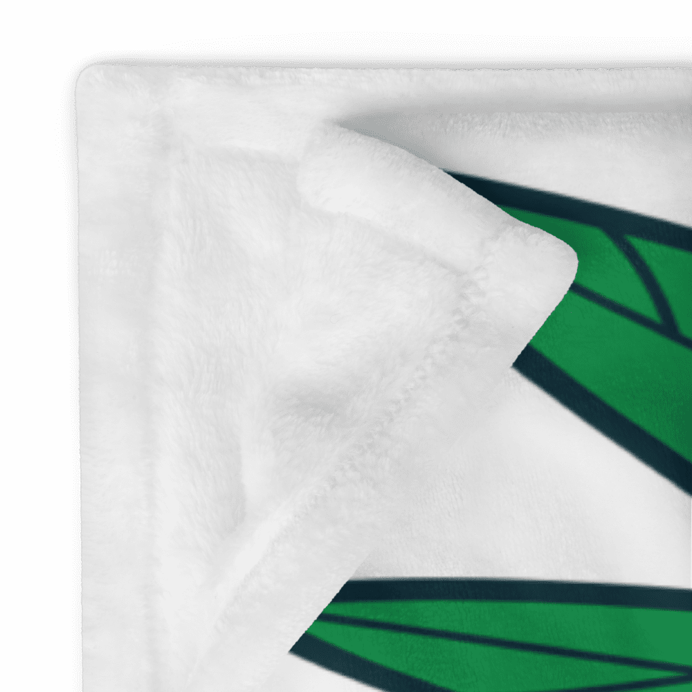 White blanket with green geometric design.
