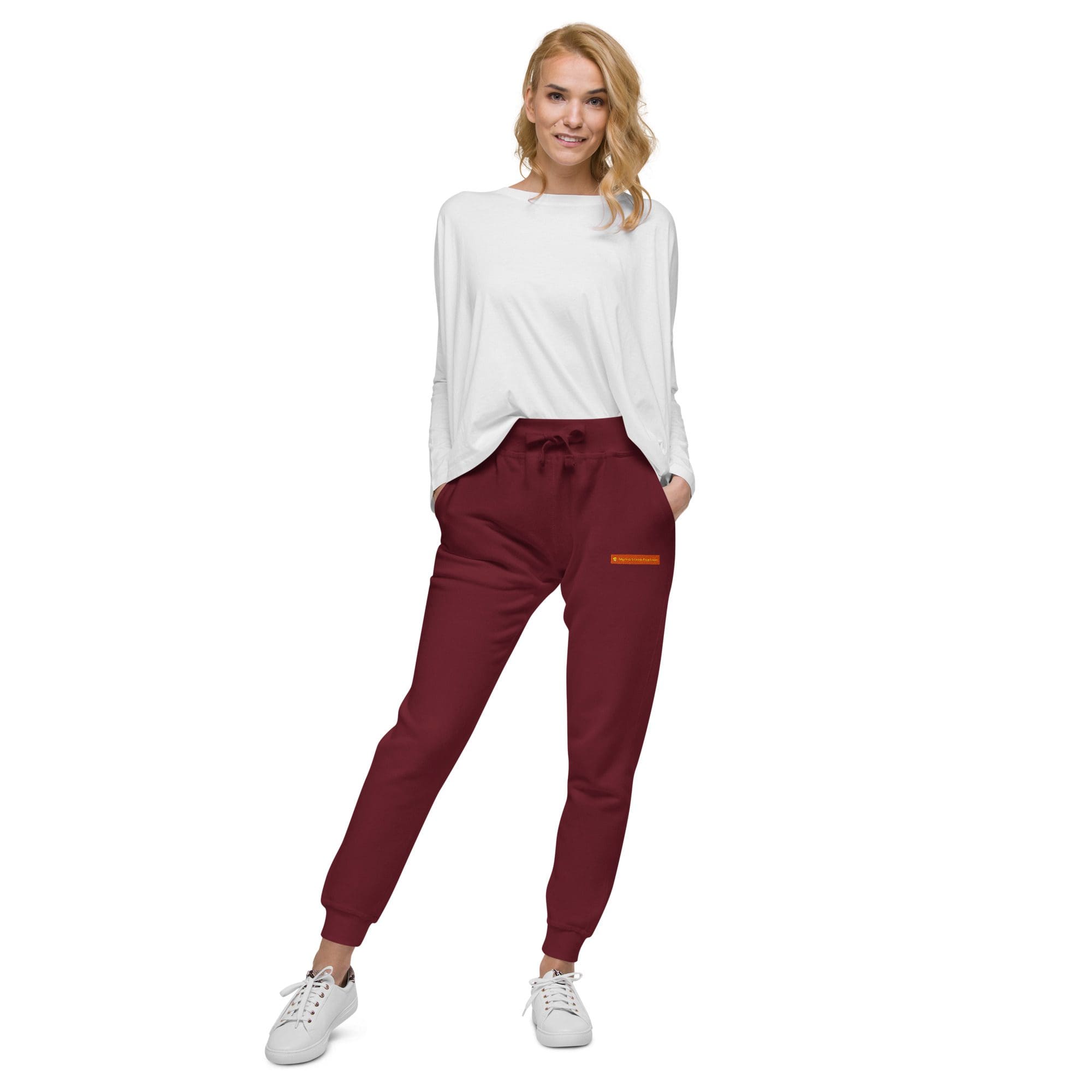 Woman in white top and maroon pants.