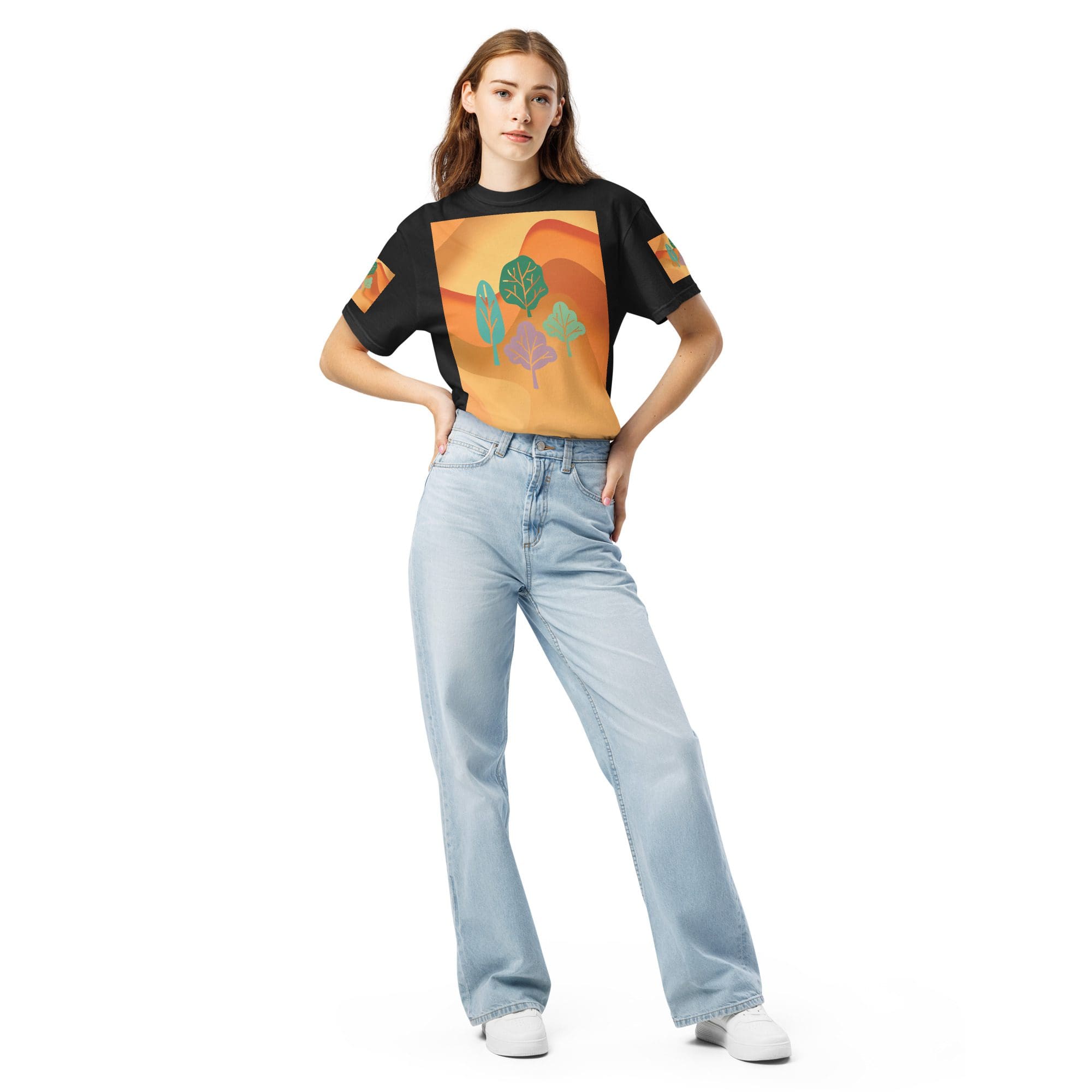 Woman in graphic tee and jeans posing.