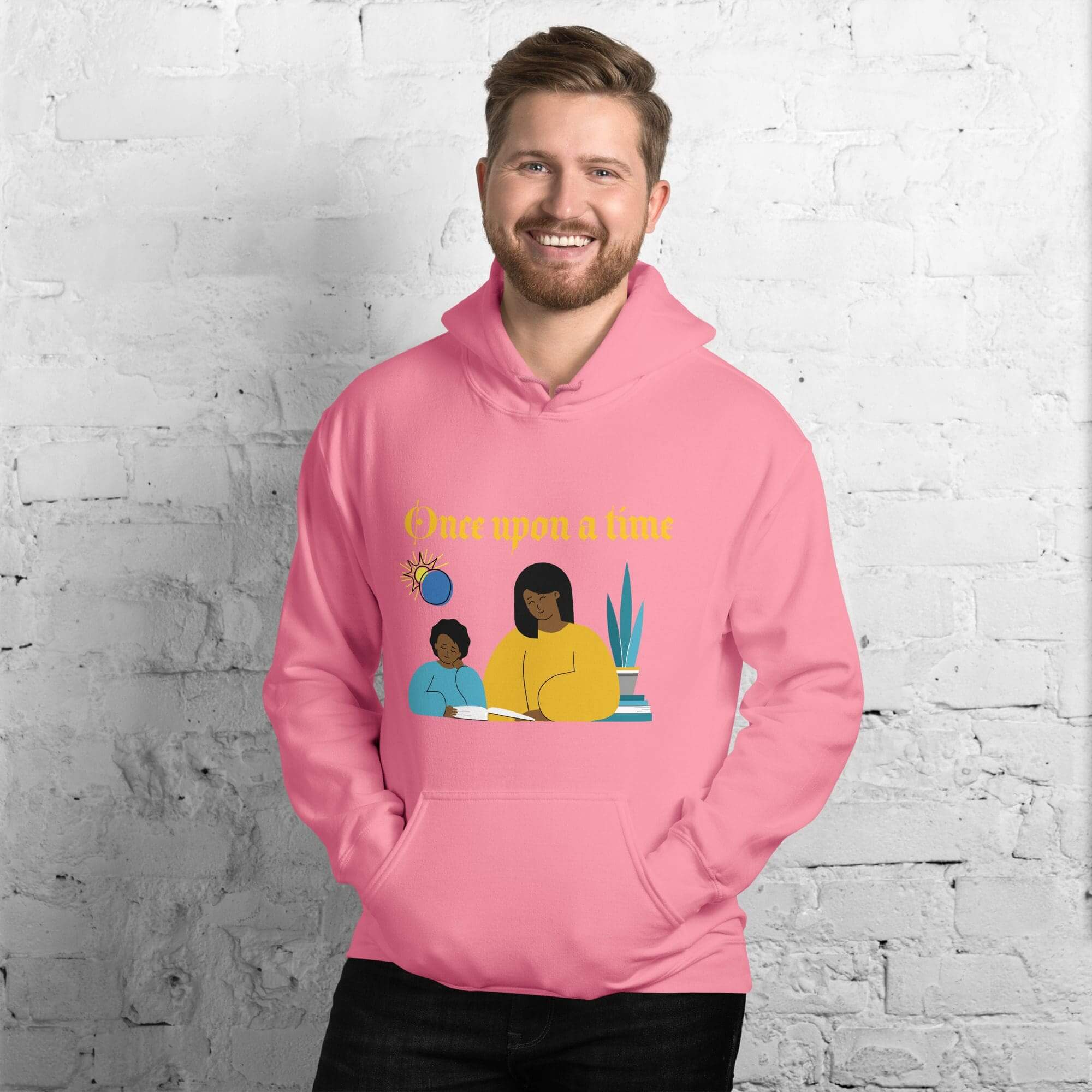 Smiling man wearing pink hoodie with storybook graphic