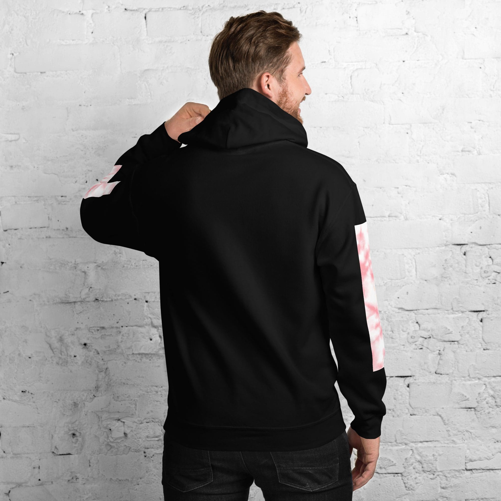 Man wearing black hoodie with pink sleeves.