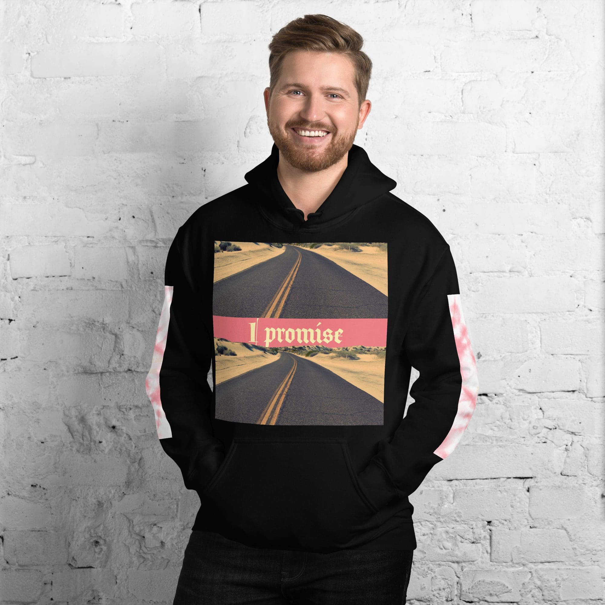 Man wearing "I promise" hoodie, smiling.