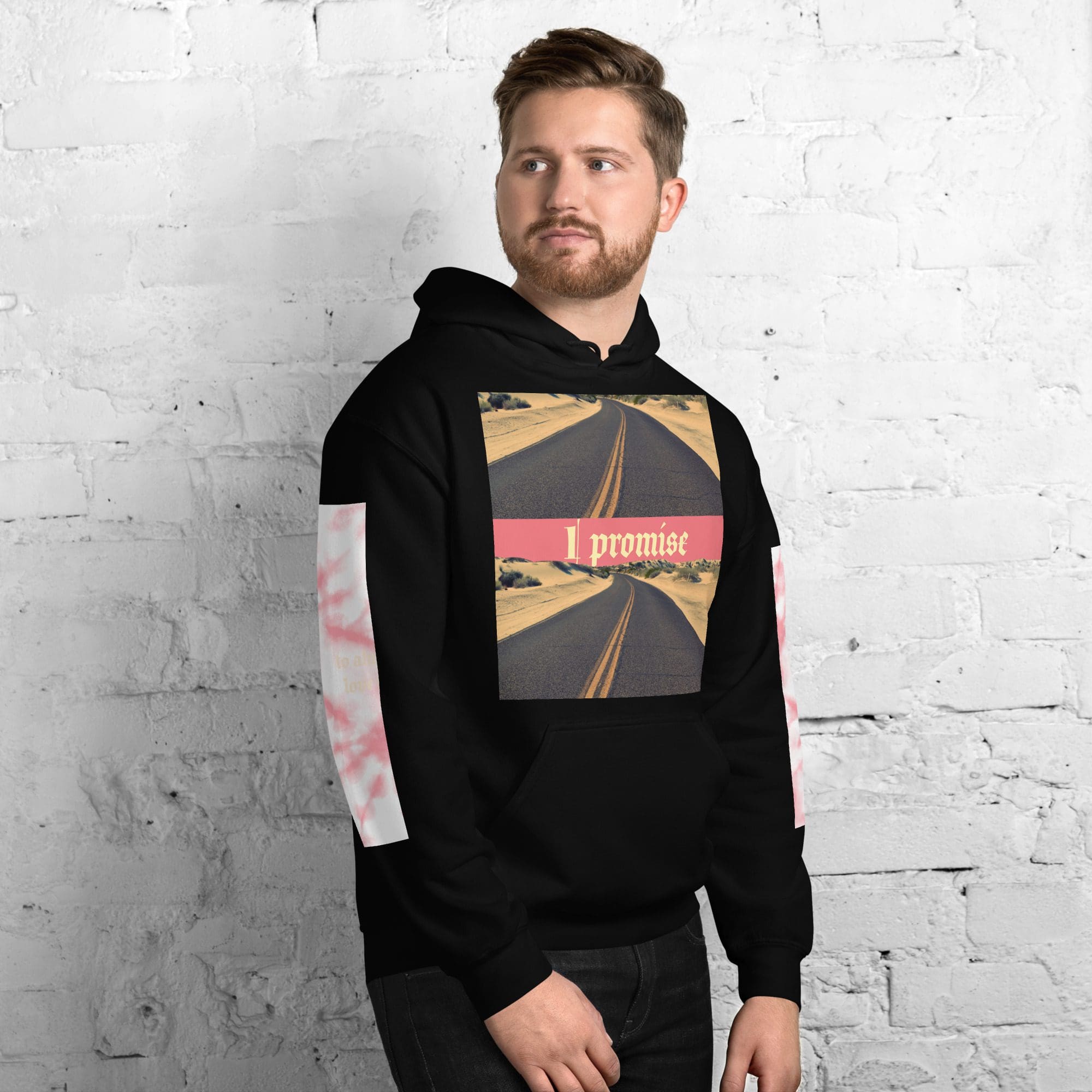 Man wearing "I promise" hoodie, white wall.
