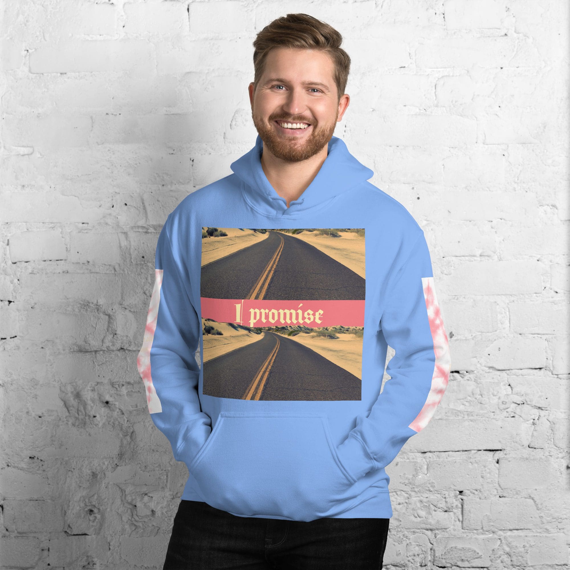 Smiling man in blue hoodie reading 'I promise'