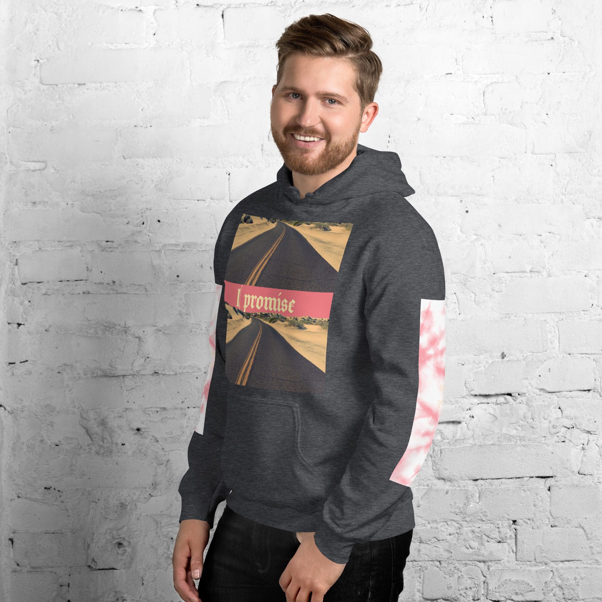 Man wearing a graphic hoodie, smiling.