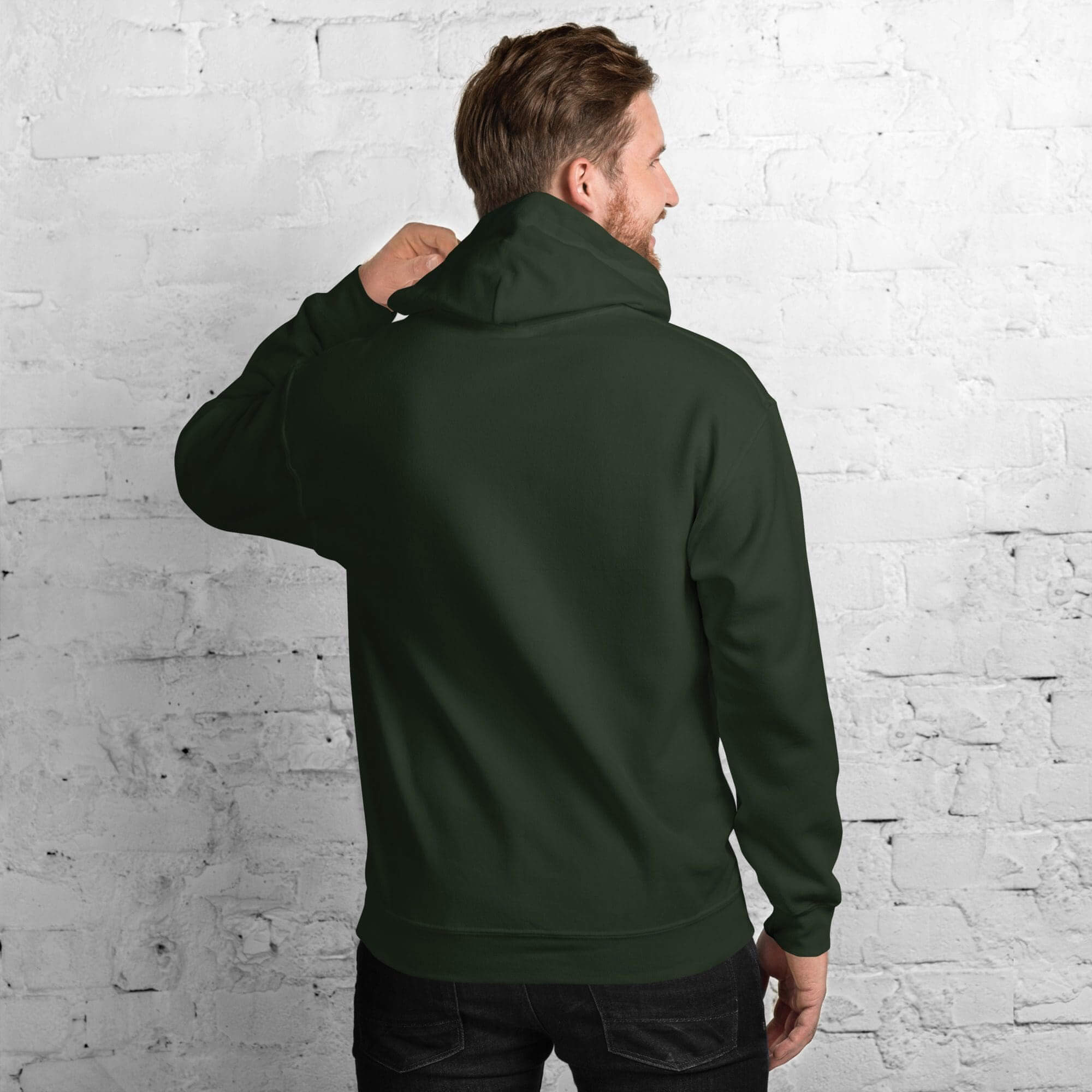 Man adjusting dark green hoodie, back view