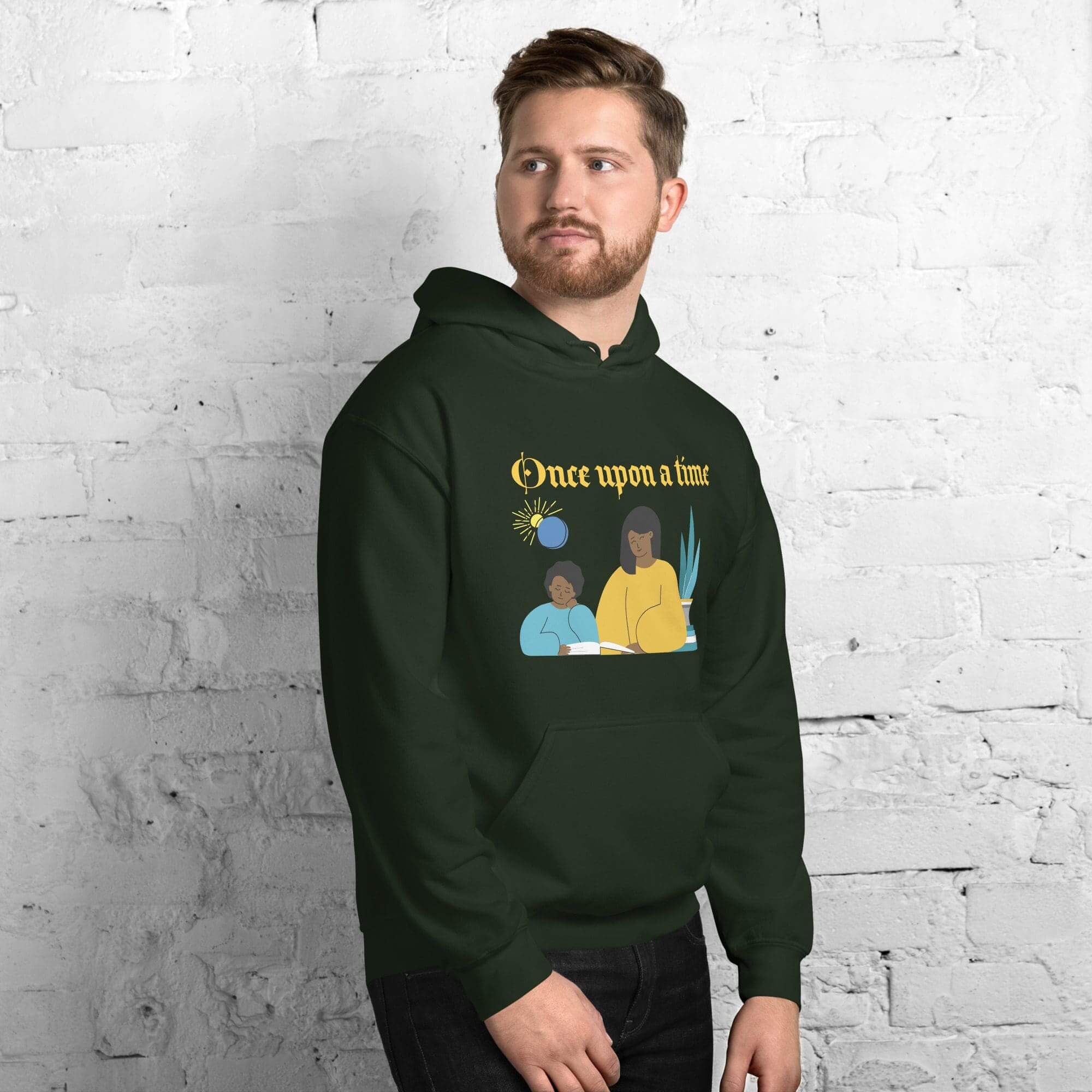 Man wearing a green hoodie, brick background.