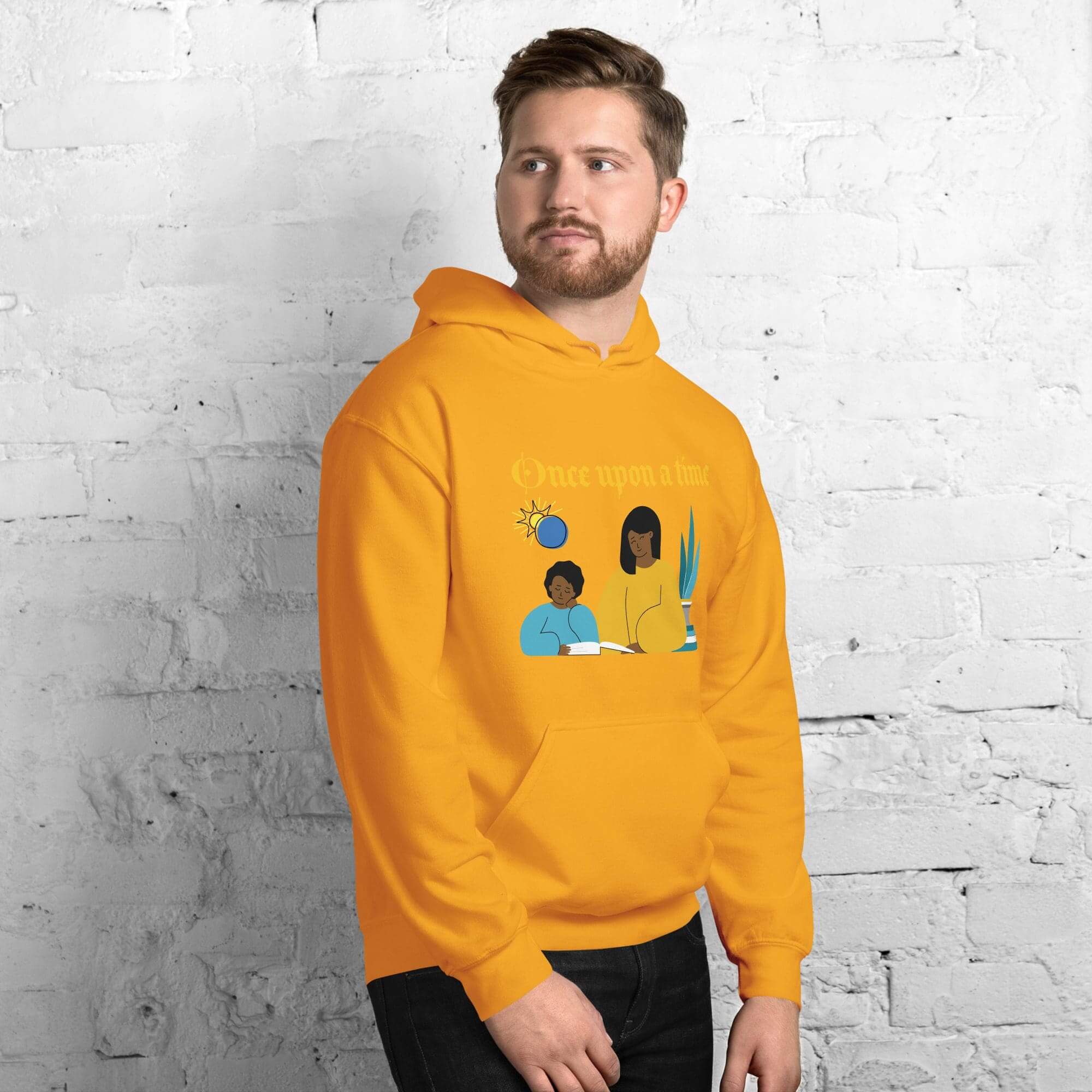 Person wearing yellow hoodie with graphic design.