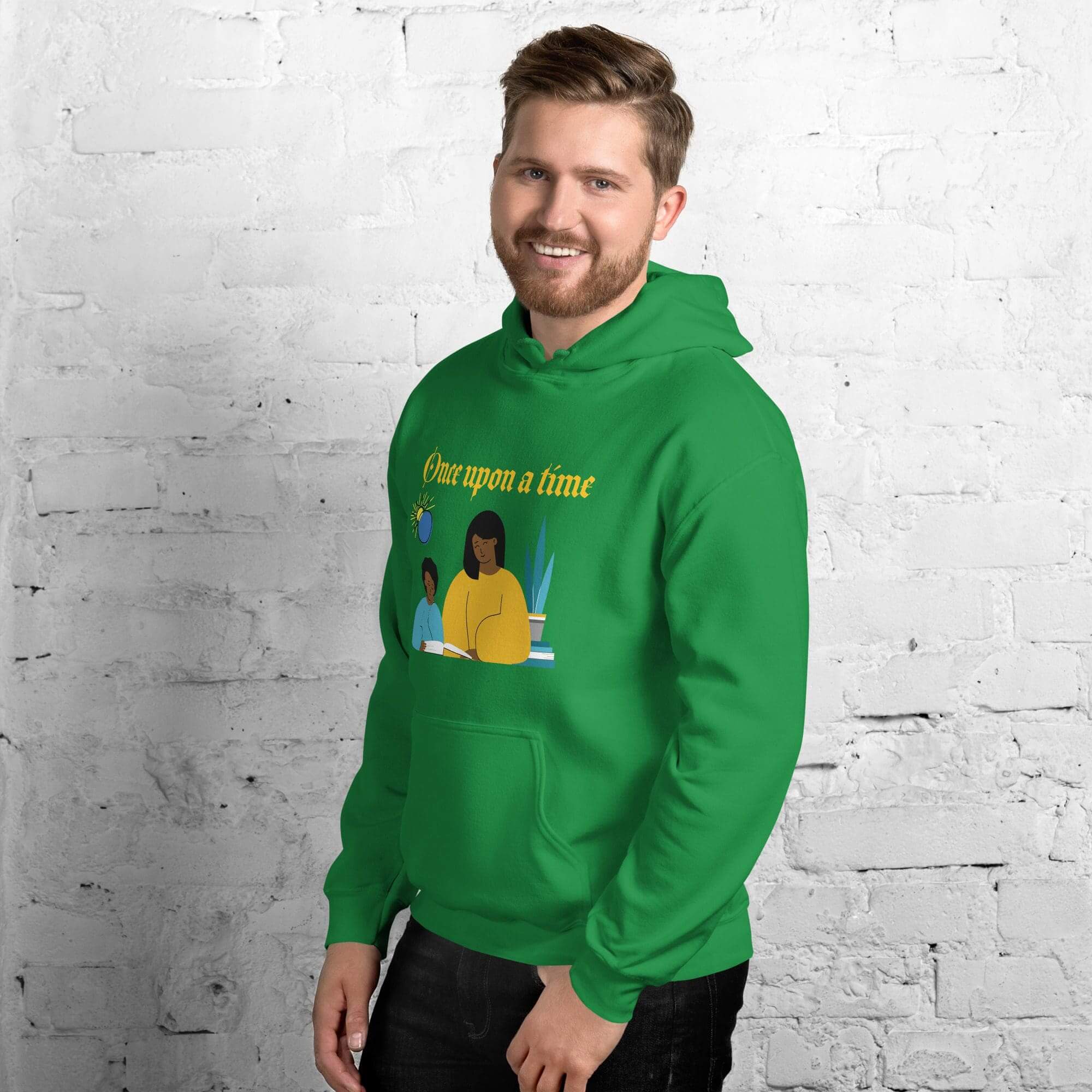 Man wearing green hoodie, white brick background.