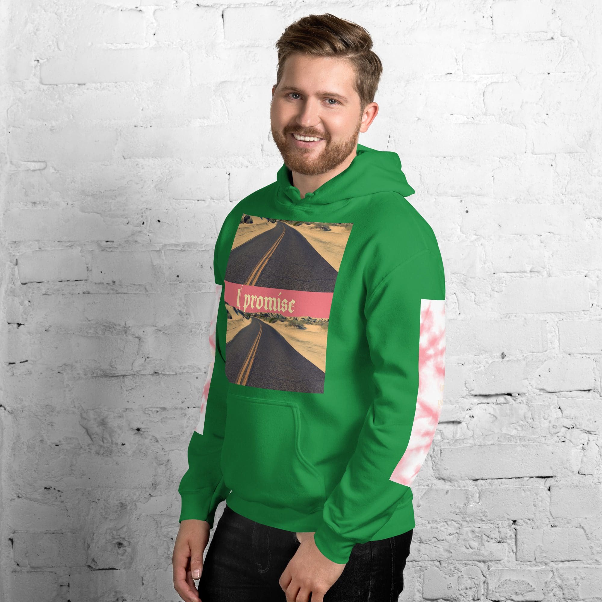 Man wearing green hoodie, brick wall background.