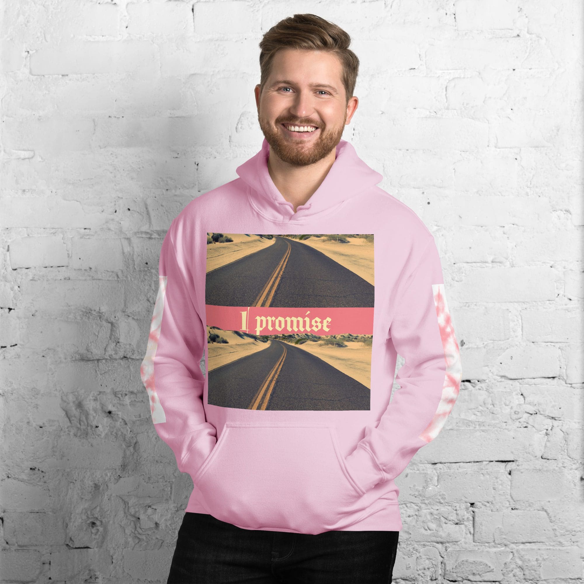 Man wearing a pink hoodie, brick background.