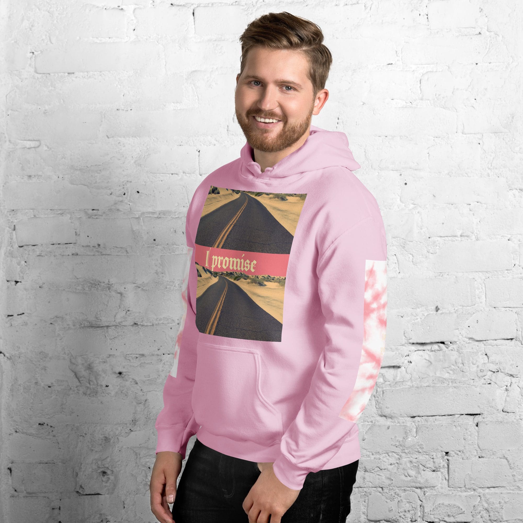 Smiling man in pink hoodie with road graphic