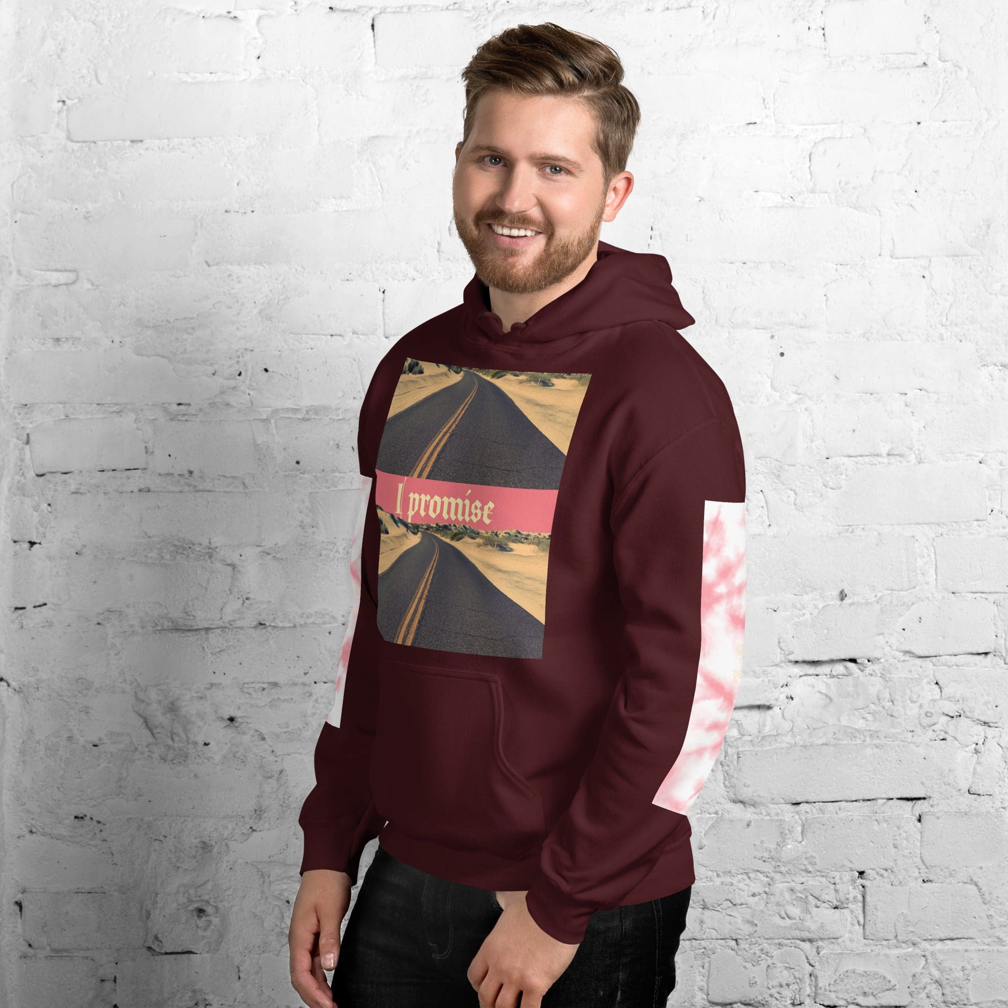 Man wearing maroon hoodie, brick wall background.