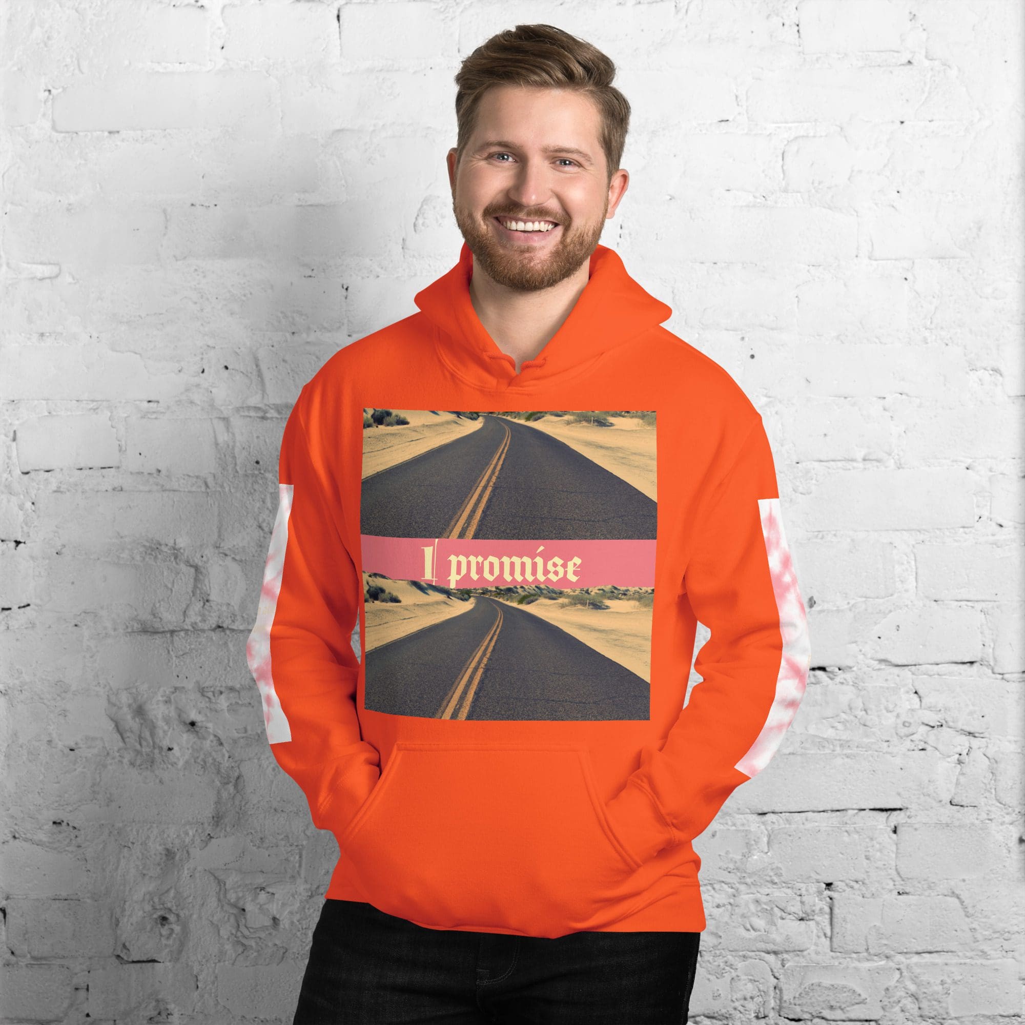 Smiling man wearing orange hoodie with road print