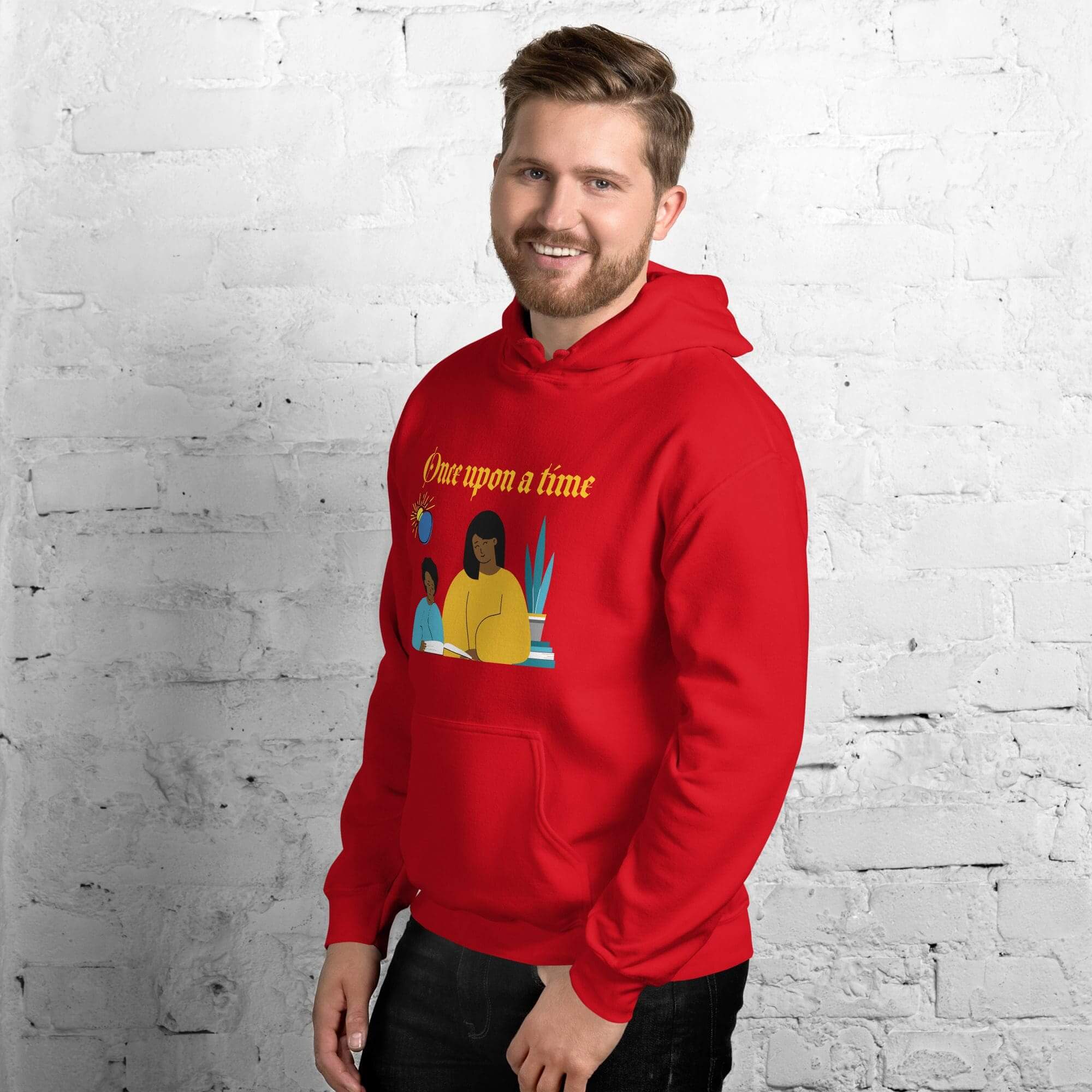 Man in red hoodie with illustration, smiling.