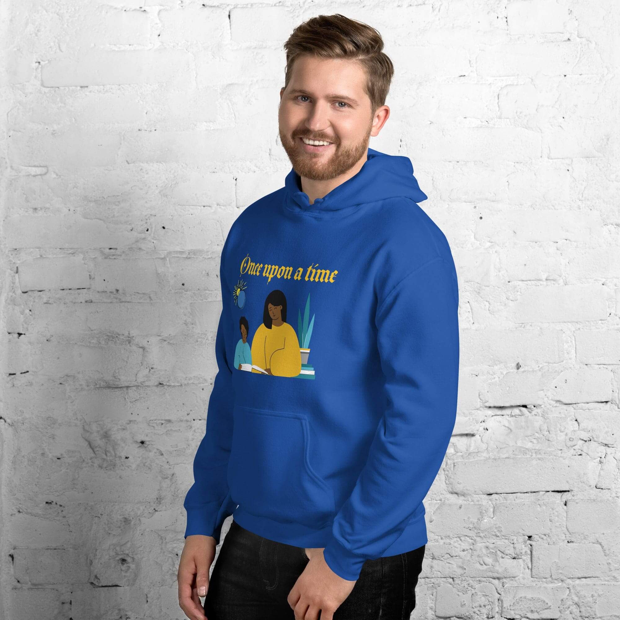 Man wearing blue hoodie, white brick background.