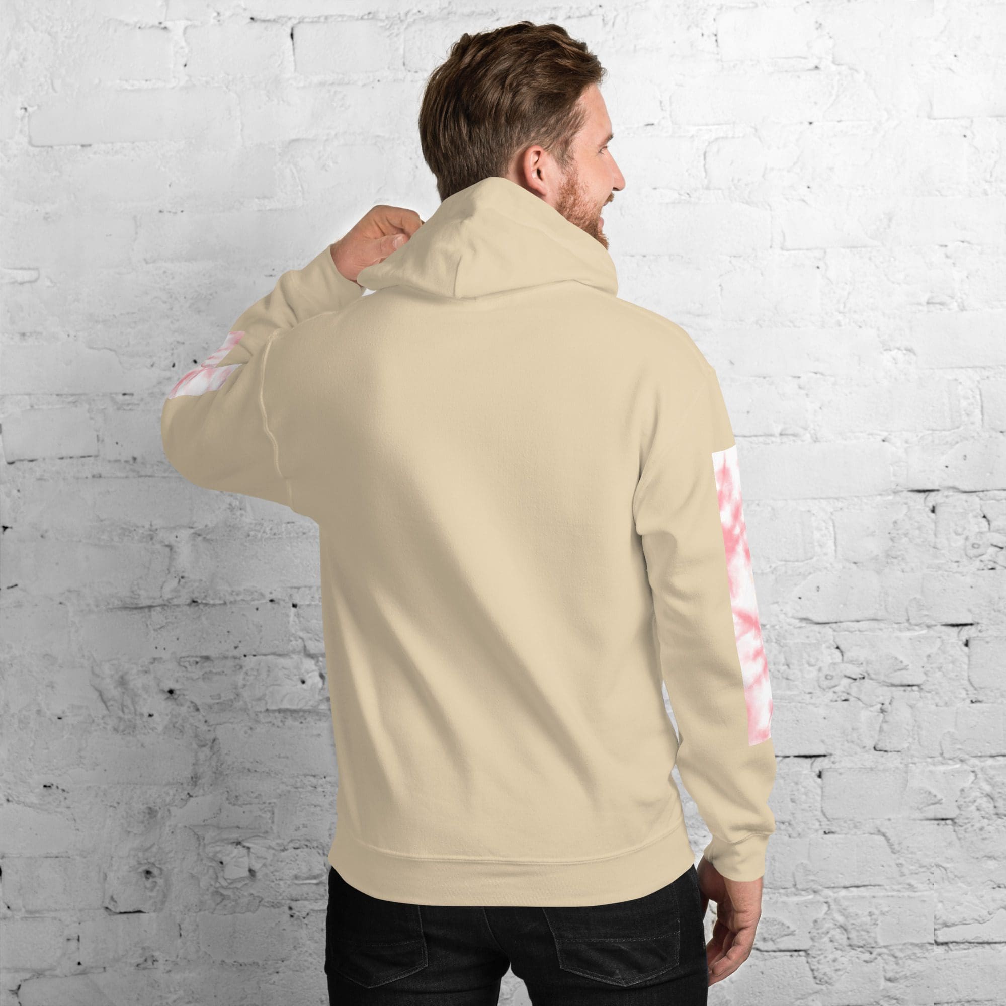 Man wearing beige hoodie with tie-dye sleeves.
