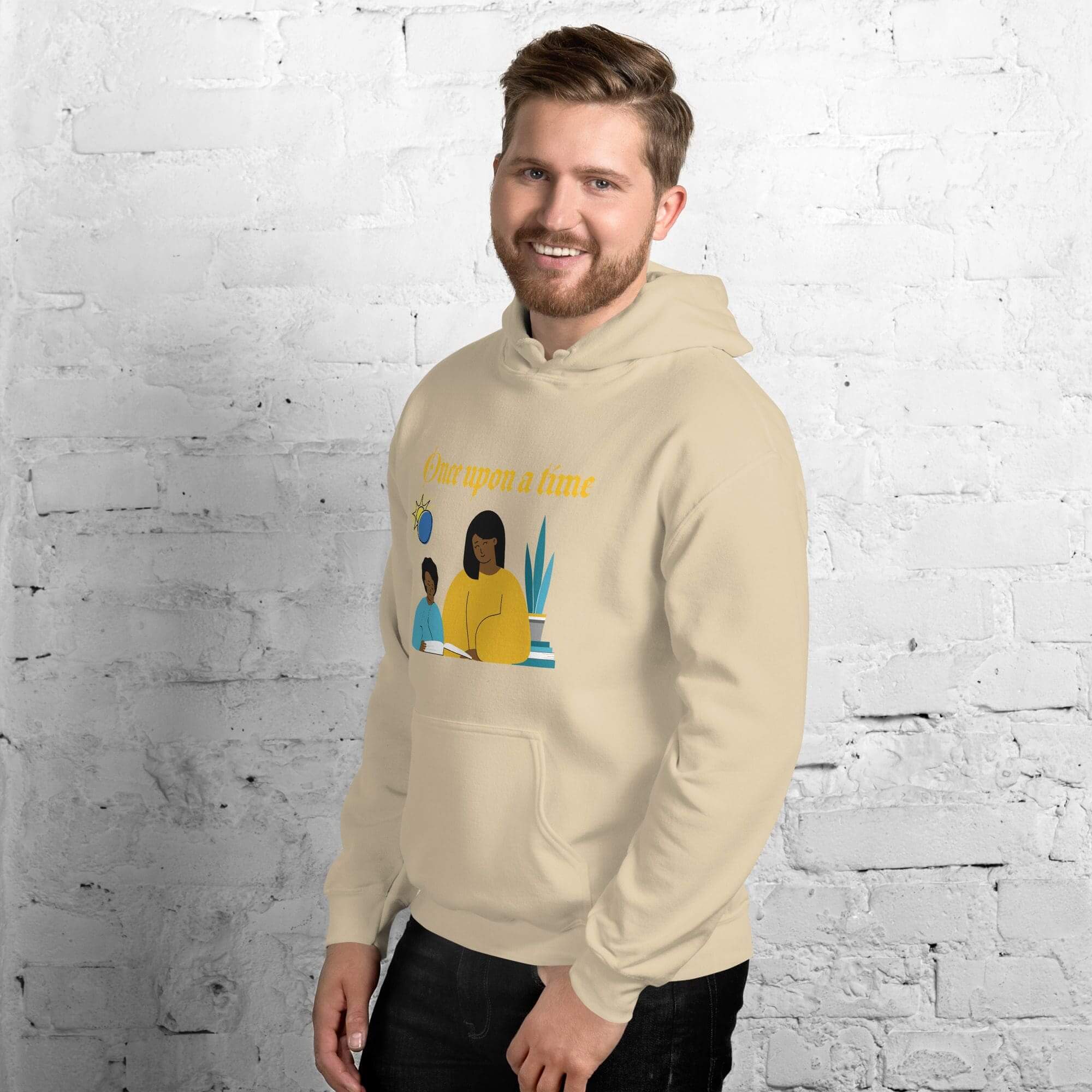 Smiling man in beige hoodie with graphic