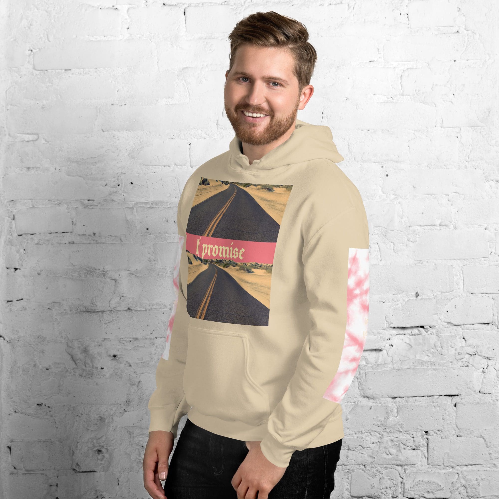 Smiling man wearing beige hoodie with road print