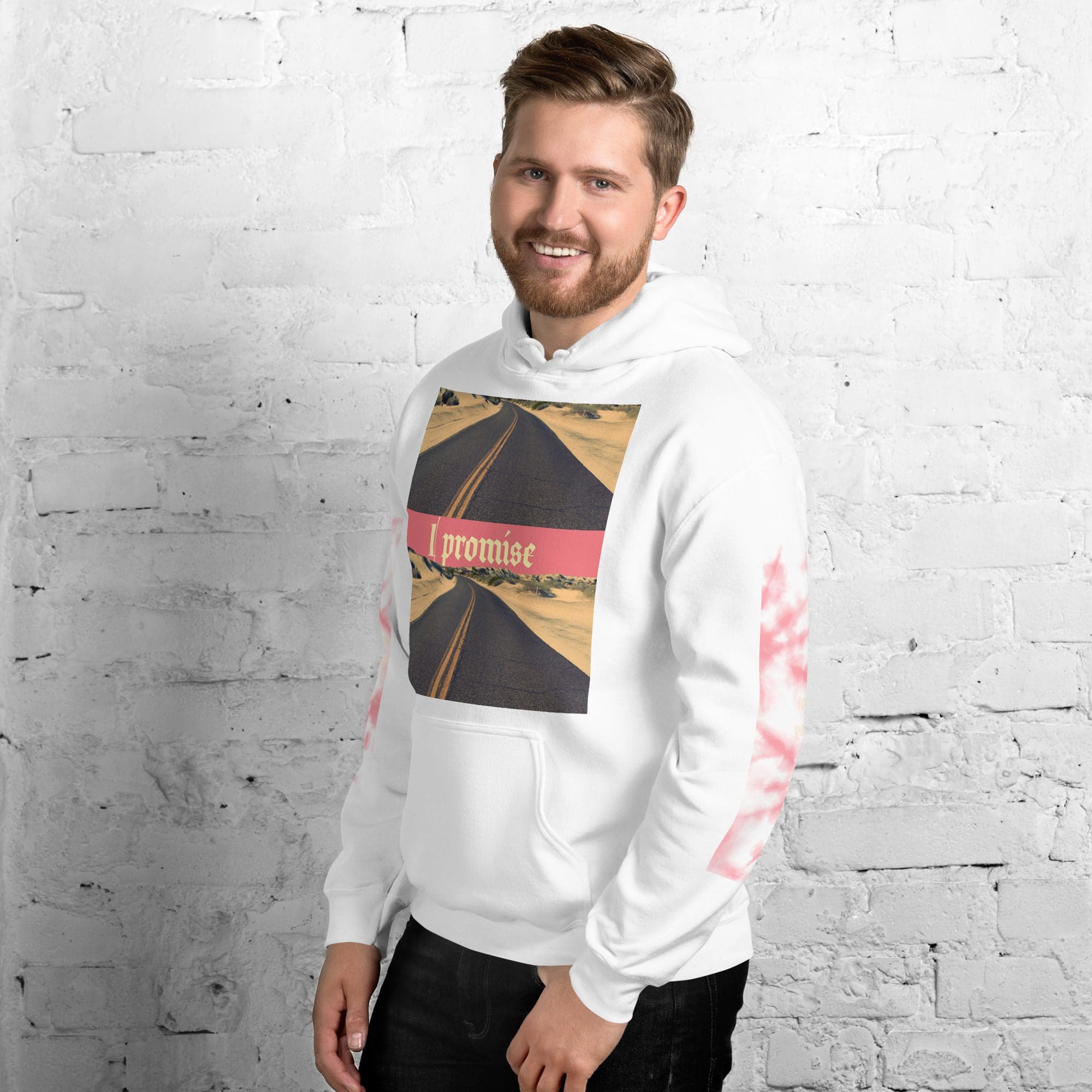 Smiling man in white hoodie with road graphic