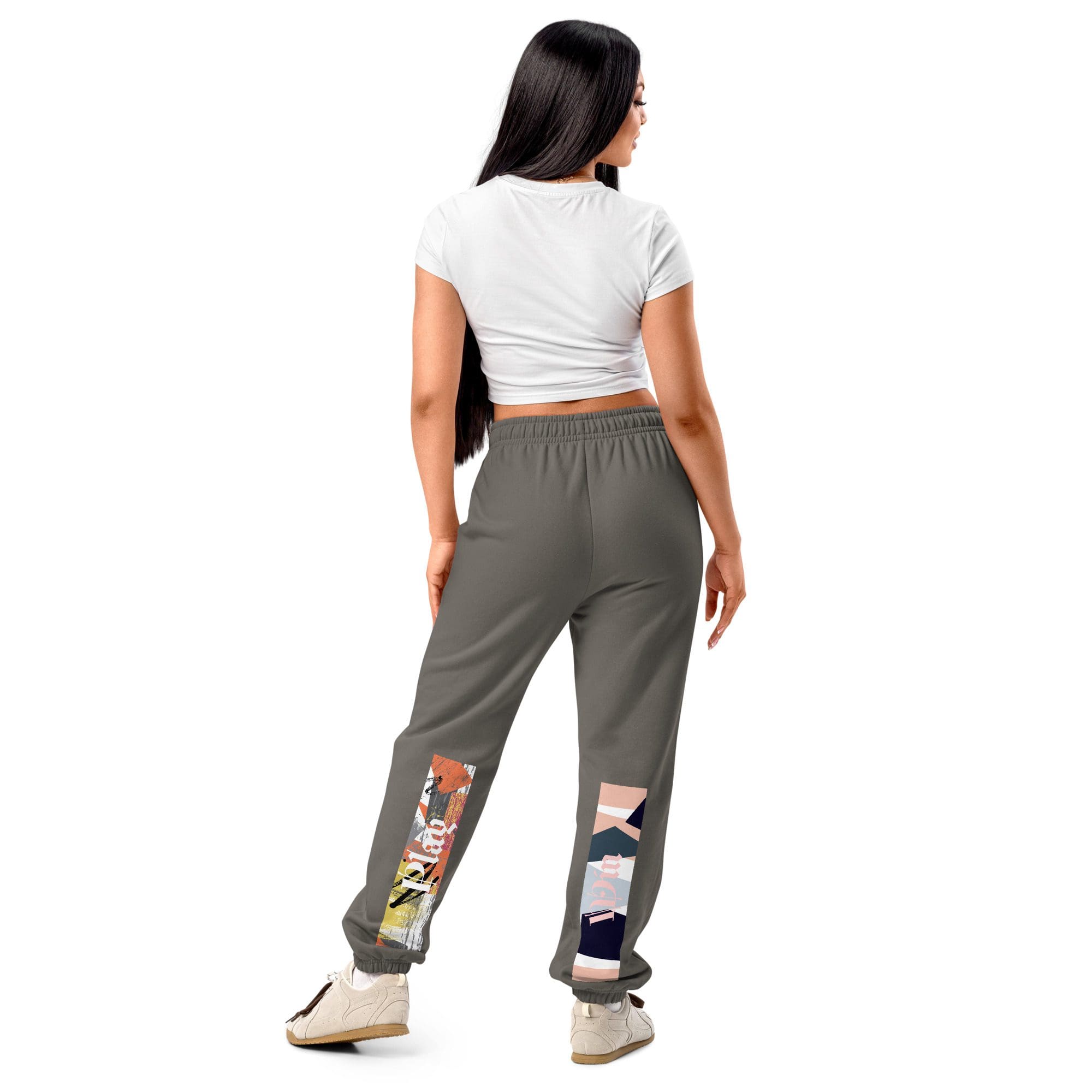 Woman wearing stylish graphic sweatpants and sneakers.