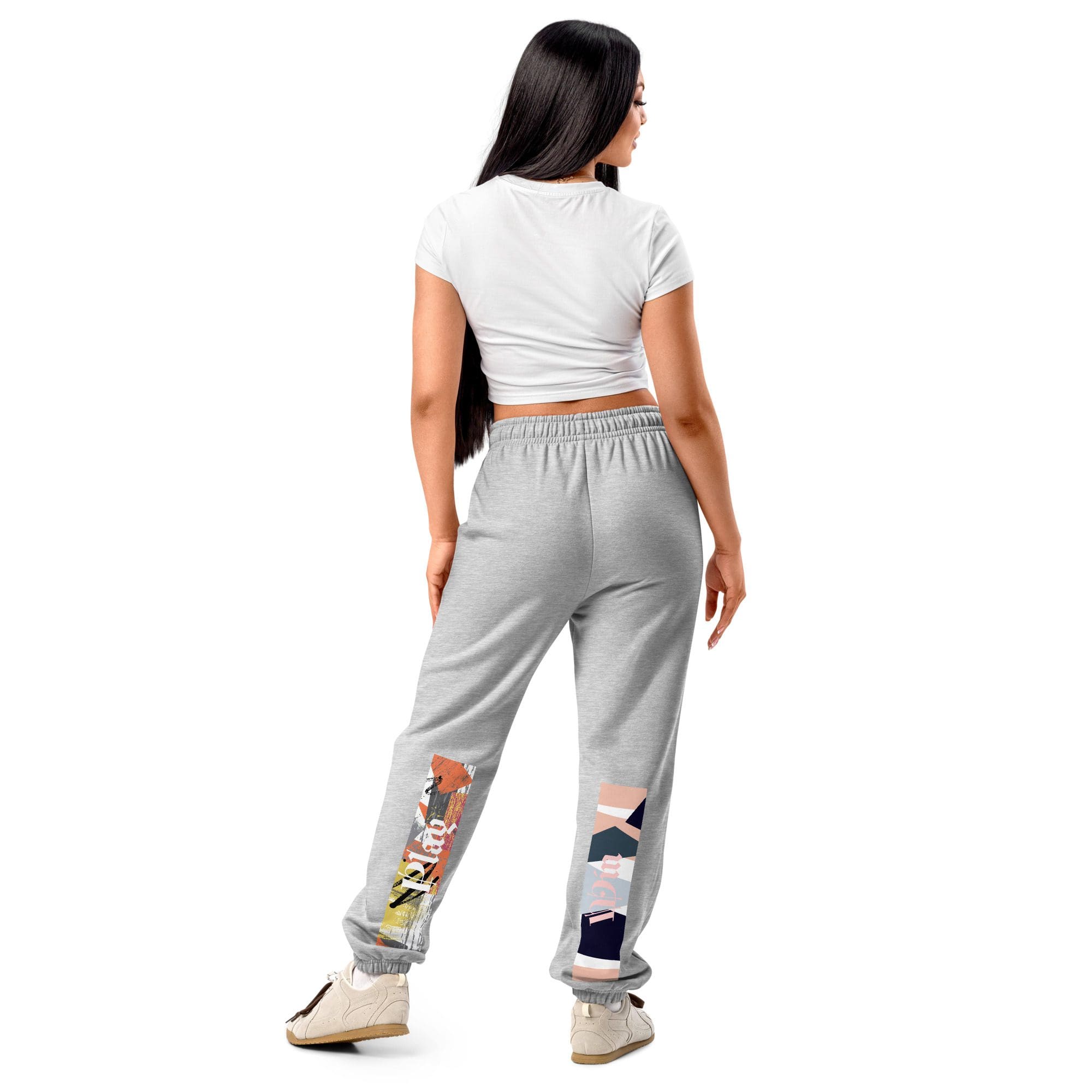 Woman wearing graphic sweatpants and white top.