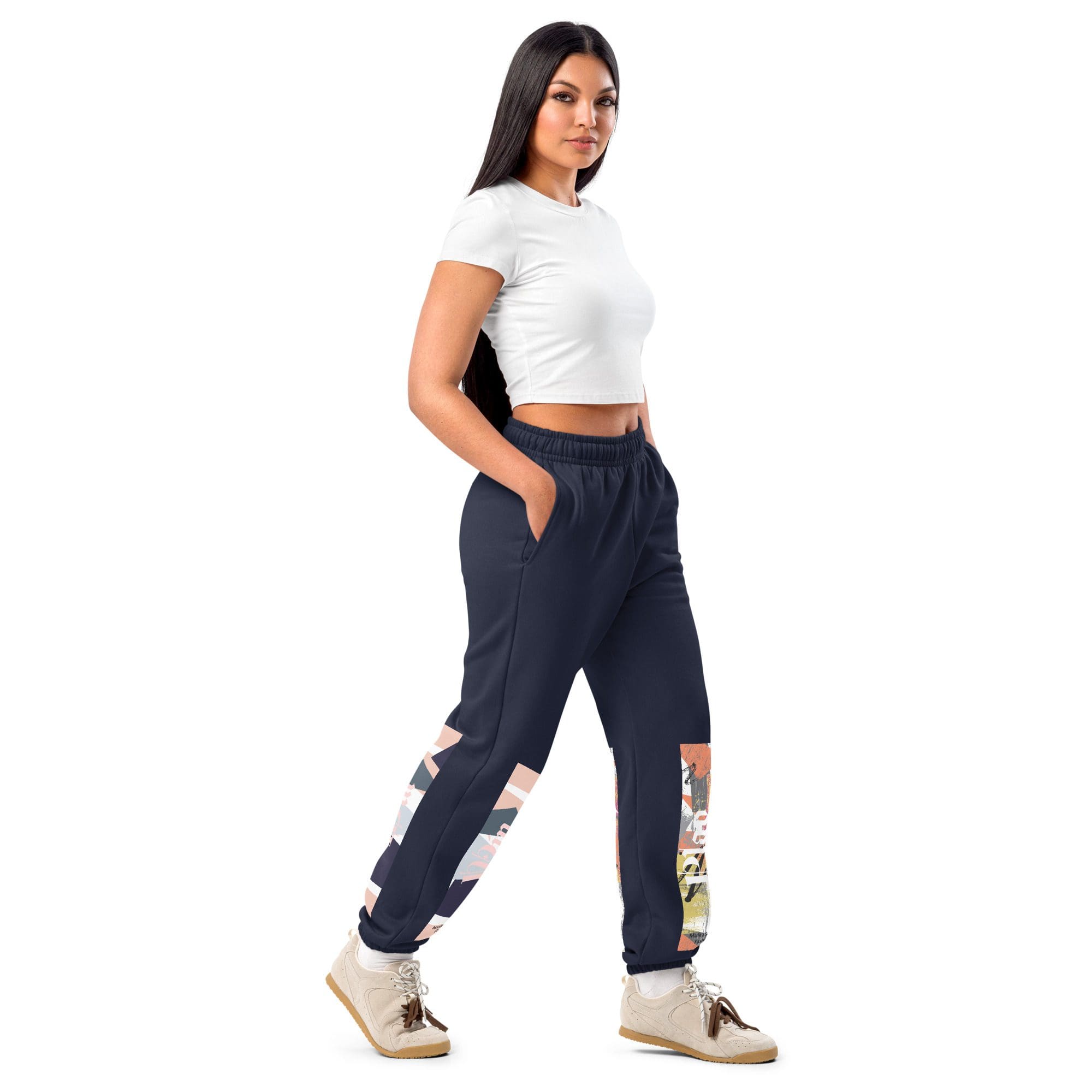 Woman posing in stylish joggers and sneakers.