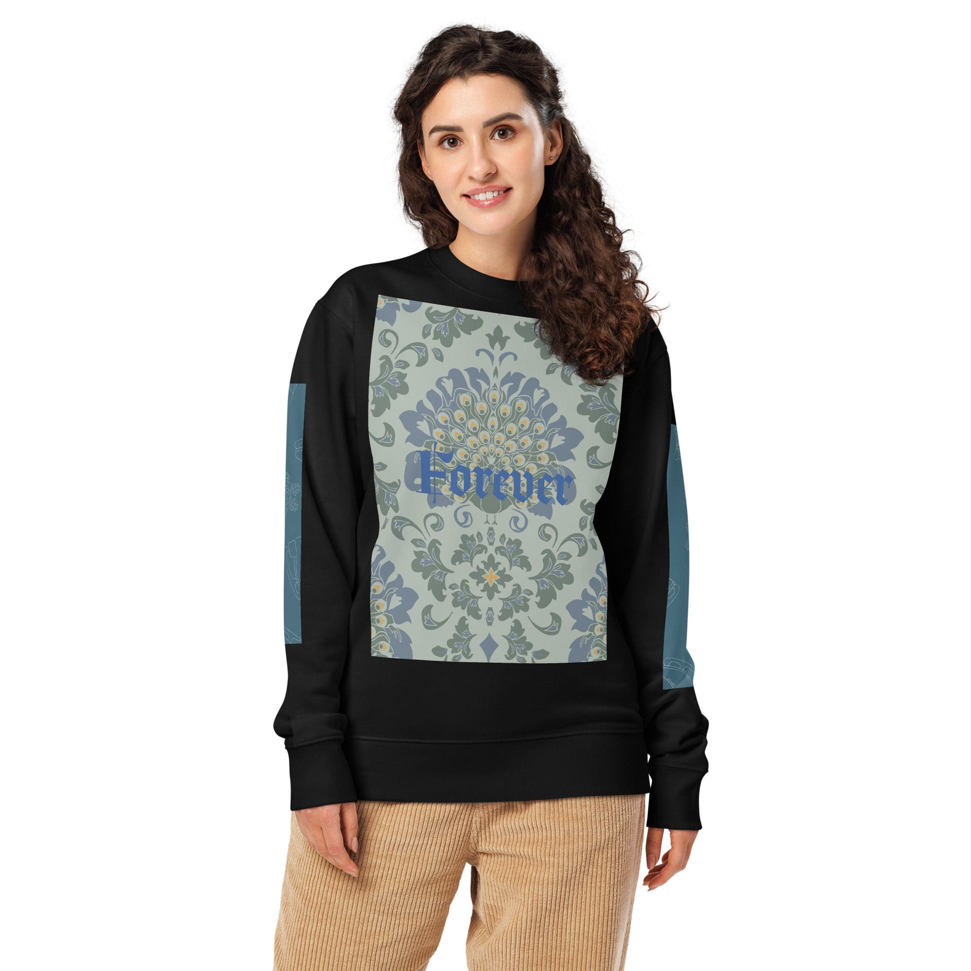 Person wearing patterned sweatshirt and corduroy pants.