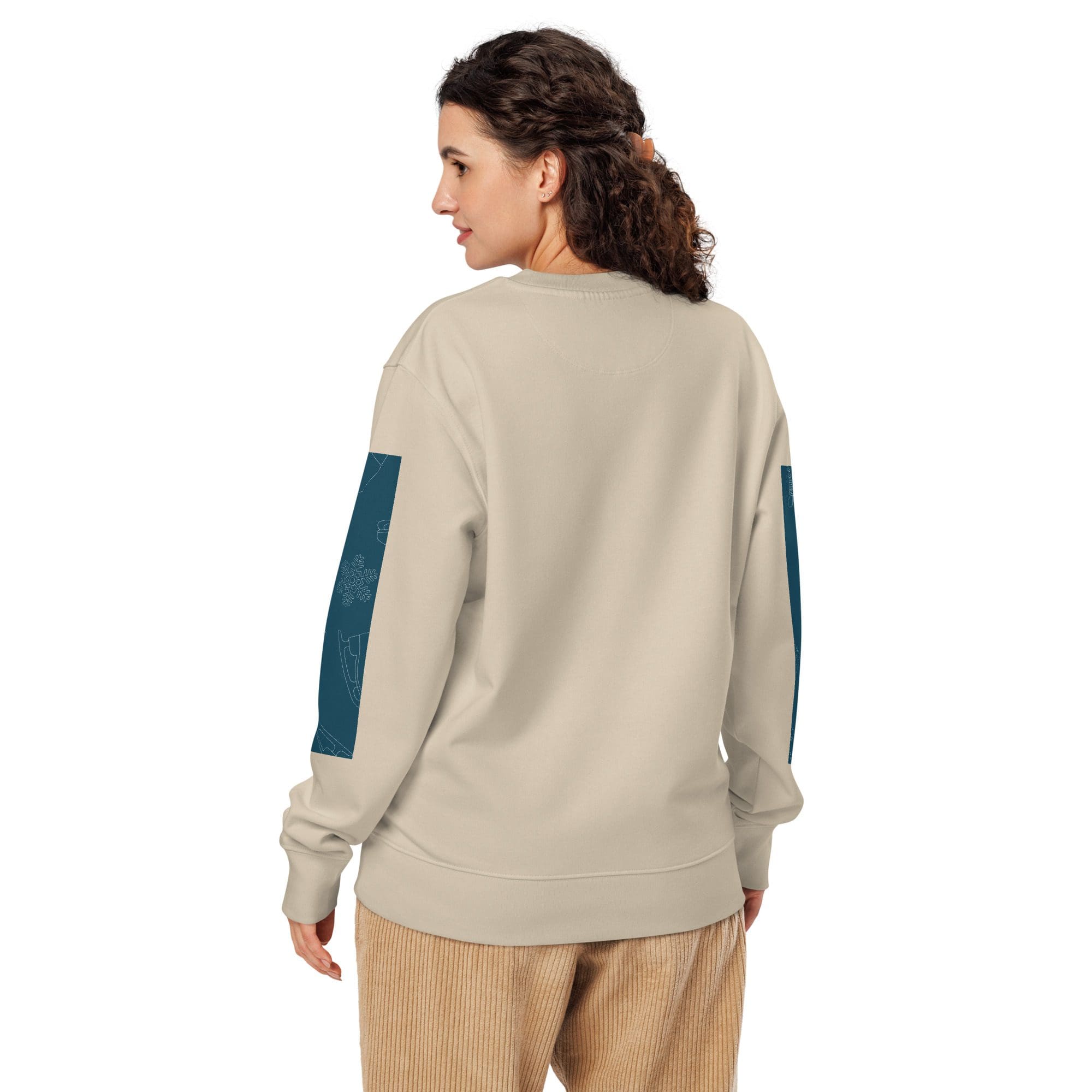 Woman wearing beige sweater, patterned sleeves.