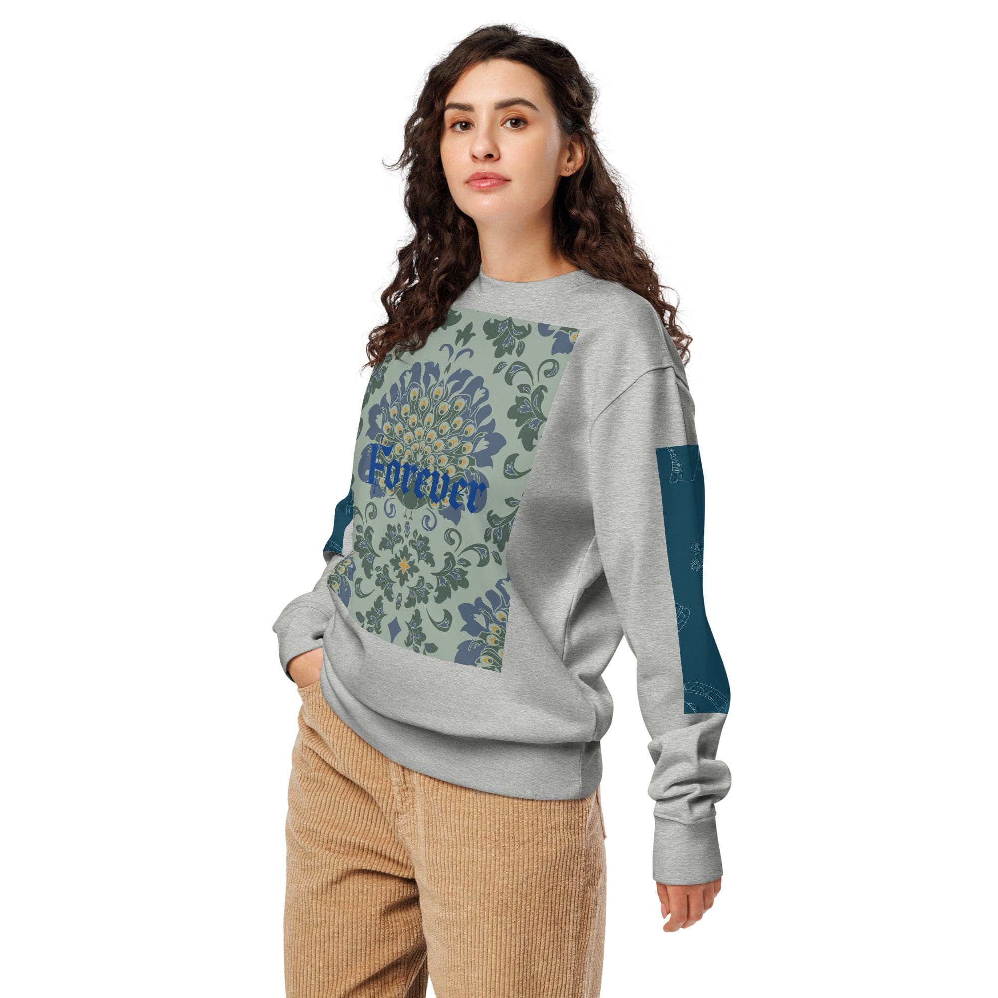 Woman wearing patterned sweatshirt and corduroy pants.